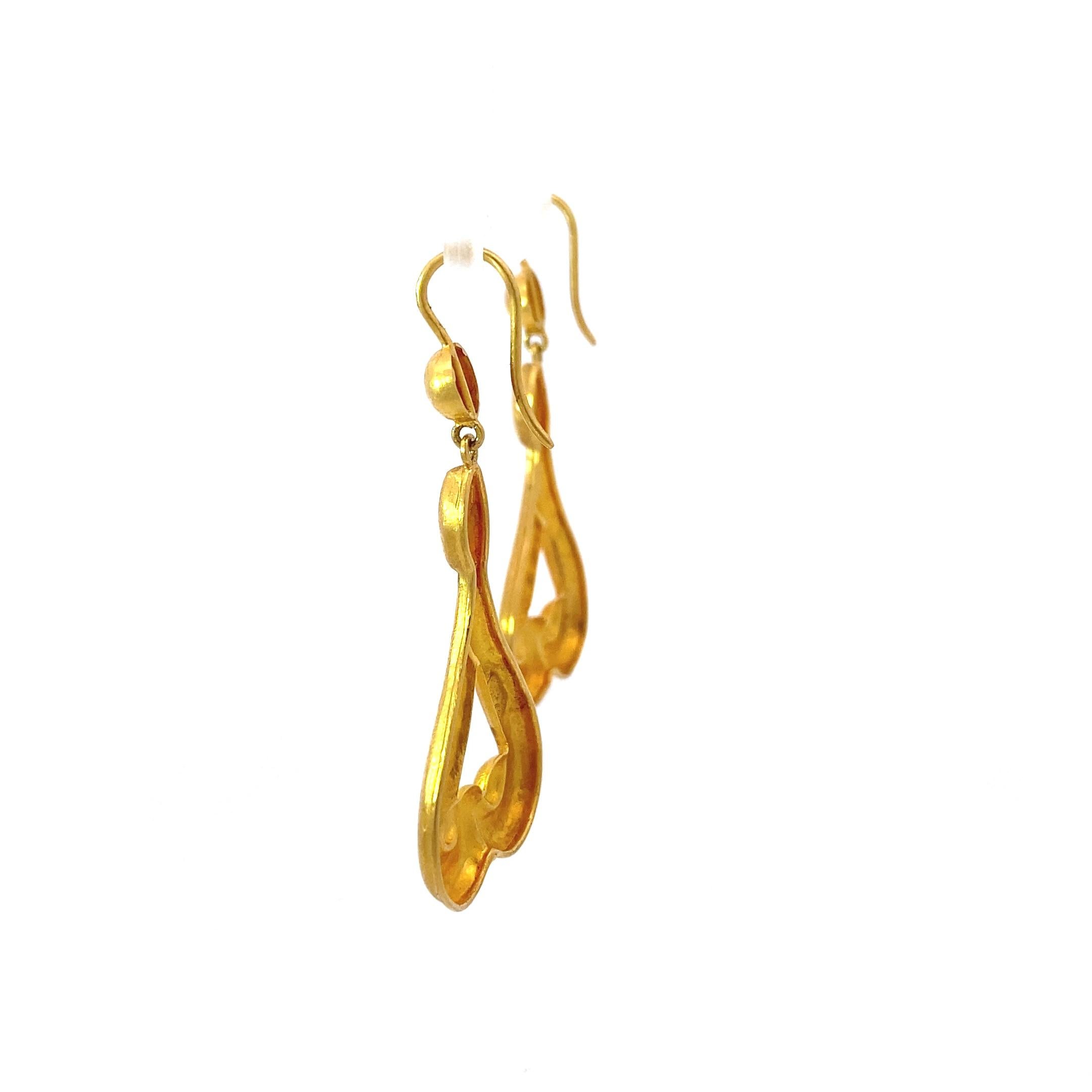 Iconic Greek imagery dangle earrings from jewelry designer LaLaounis. These earrings are an incredibly rich, buttery yellow, mimicking a much higher karat gold as well as ancient jewelry. 

The scroll like, organic triangle shape flatters the face