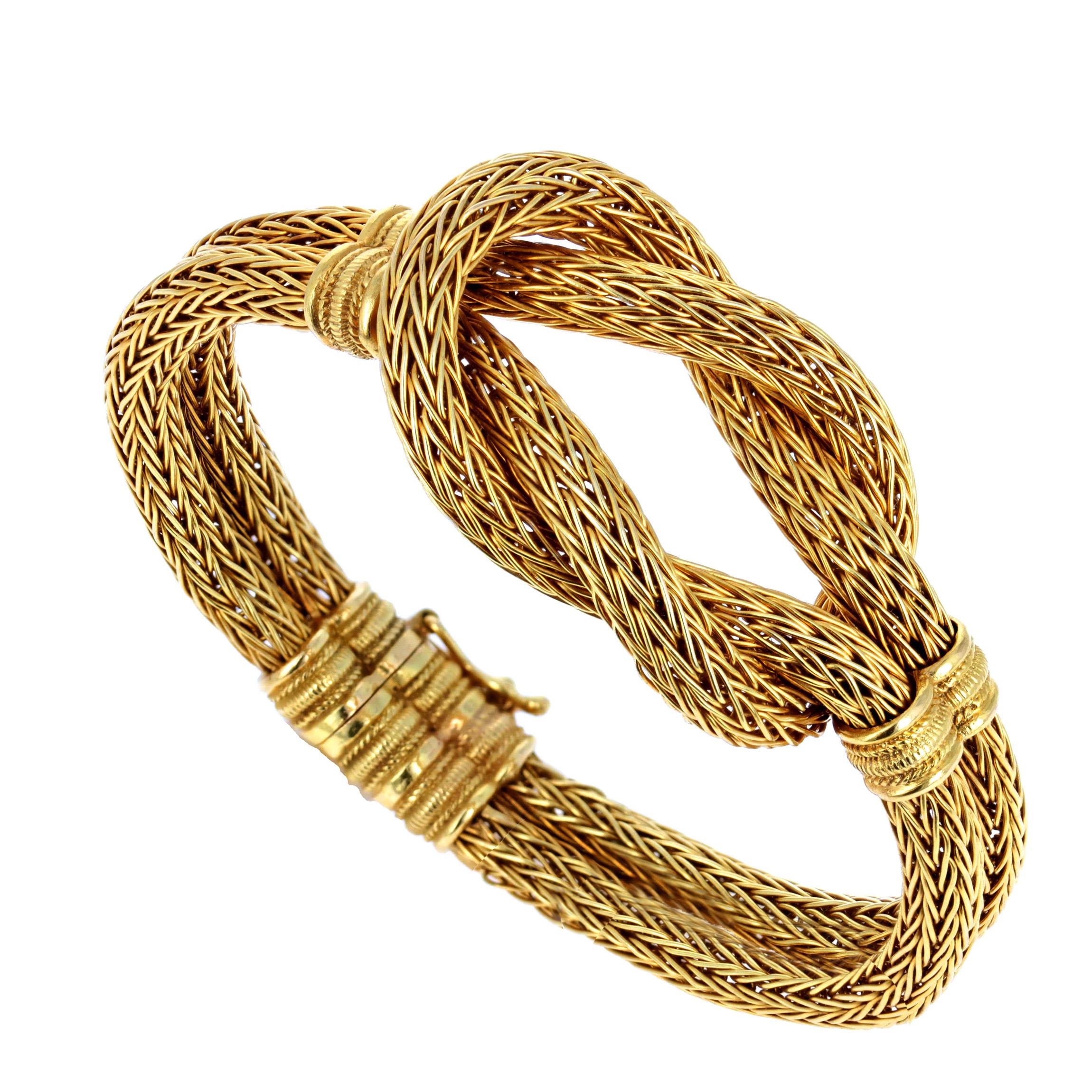 A round woven 18k gold chain fashioned into a flexible Hercules knot from the self-named collection by Athenian jeweler, Ilias Lalaounis. 

The ancient Hercules knot is a wedding symbol of binding love and strength, and also symoblizes the fertility