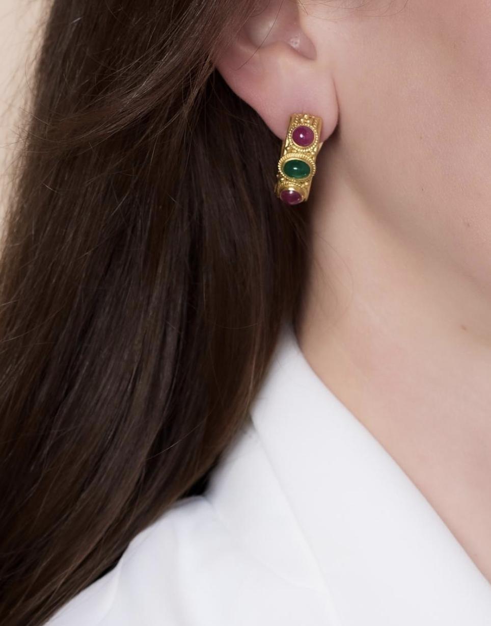 These vintage Lalaounis 18k yellow gold earrings showcase two cabochon cut emeralds totaling 2 carats, accented by four cabochon cut rubies totaling 3.40 carats. Signed and hallmarked with Greece and purity marks, they date to the 1970s, measure 1 x