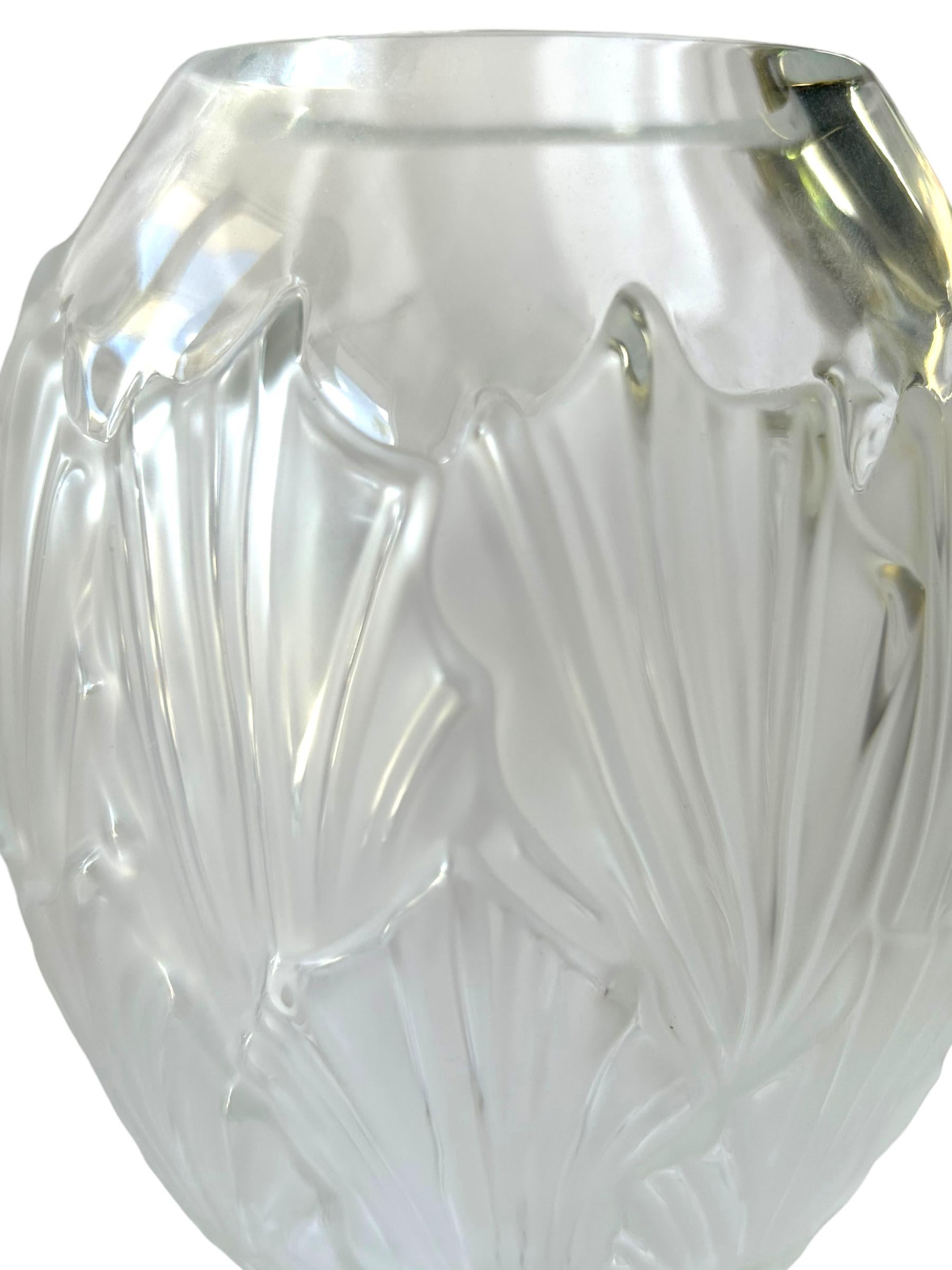 Add a touch of sophistication and elegance to your home decor with this stunning Lalique Crystal “Sandrift” Vase. The intricate design and translucent features of this exquisite vase make it a must-have for any art collector or enthusiast.  Crafted