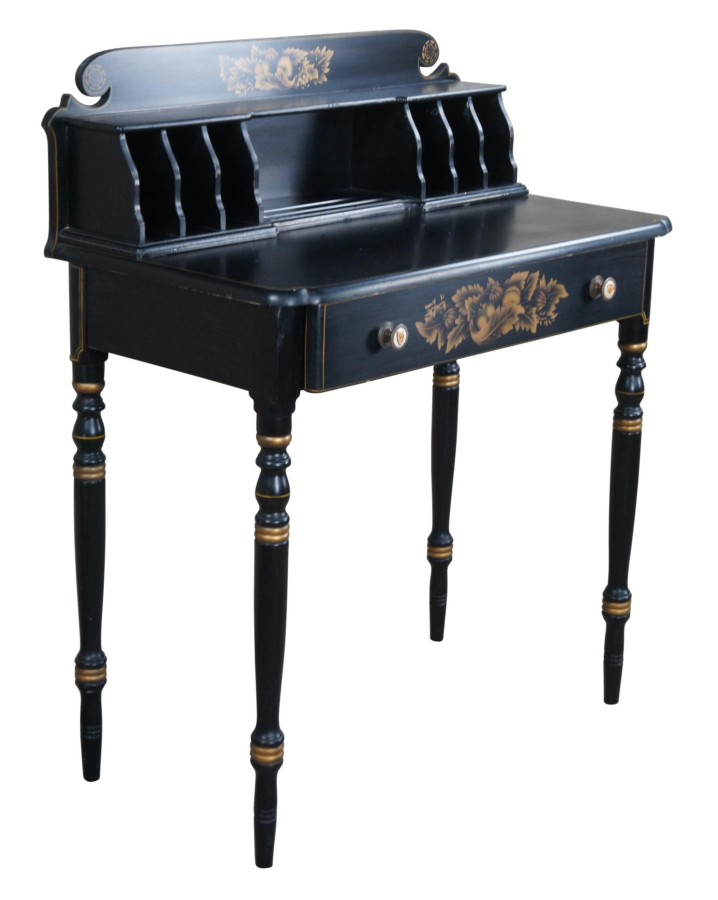 Mid 20th Century Lambert Hitchcock Black Forest stenciled ladies' secretary writing desk or console table. Made of maple featuring black ebonized finish with gold accents and stenciled arrangement of gourds and vegetables. Includes porcelain knobs