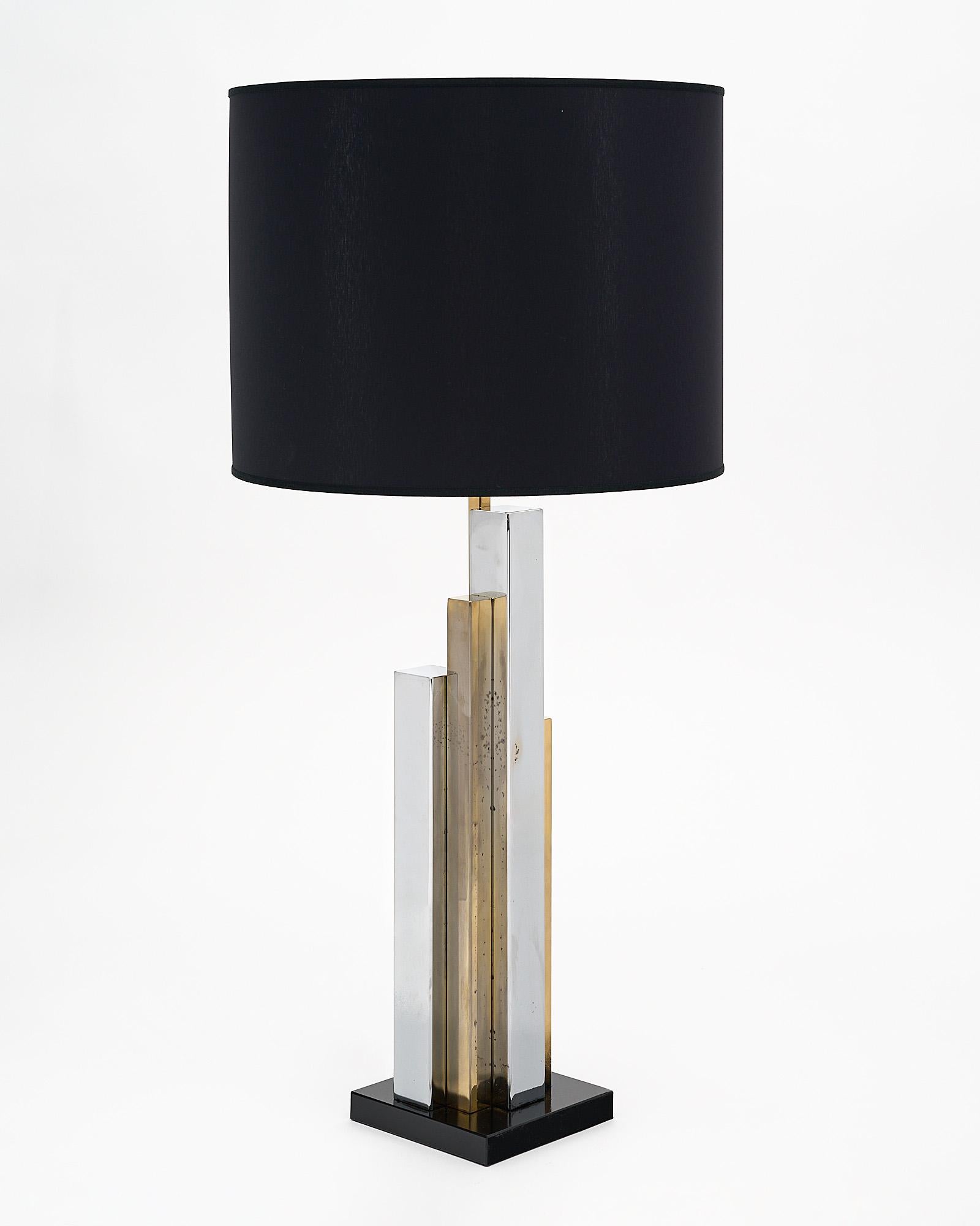 Lamp, French, by creator Philippe Cheverny. This Modernist lamp mimics a stylized skyscraper with brass and chromed steel components. It has been newly wired to fit US standards.