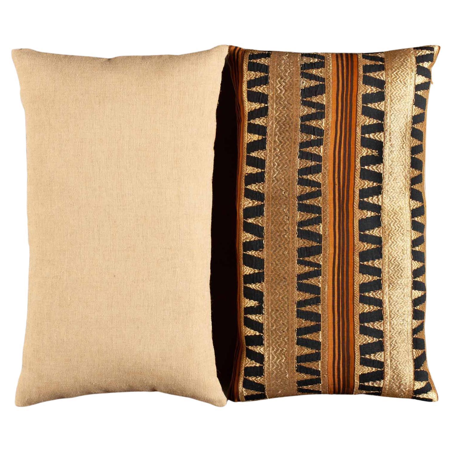 The pillow pair is crafted from a vintage Indonesian textile, most likely originating from the Lampung region of southern Sumatra. Traditionally worn as ceremonial skirts by women of high standing, tapis cloths are renowned for their handwoven