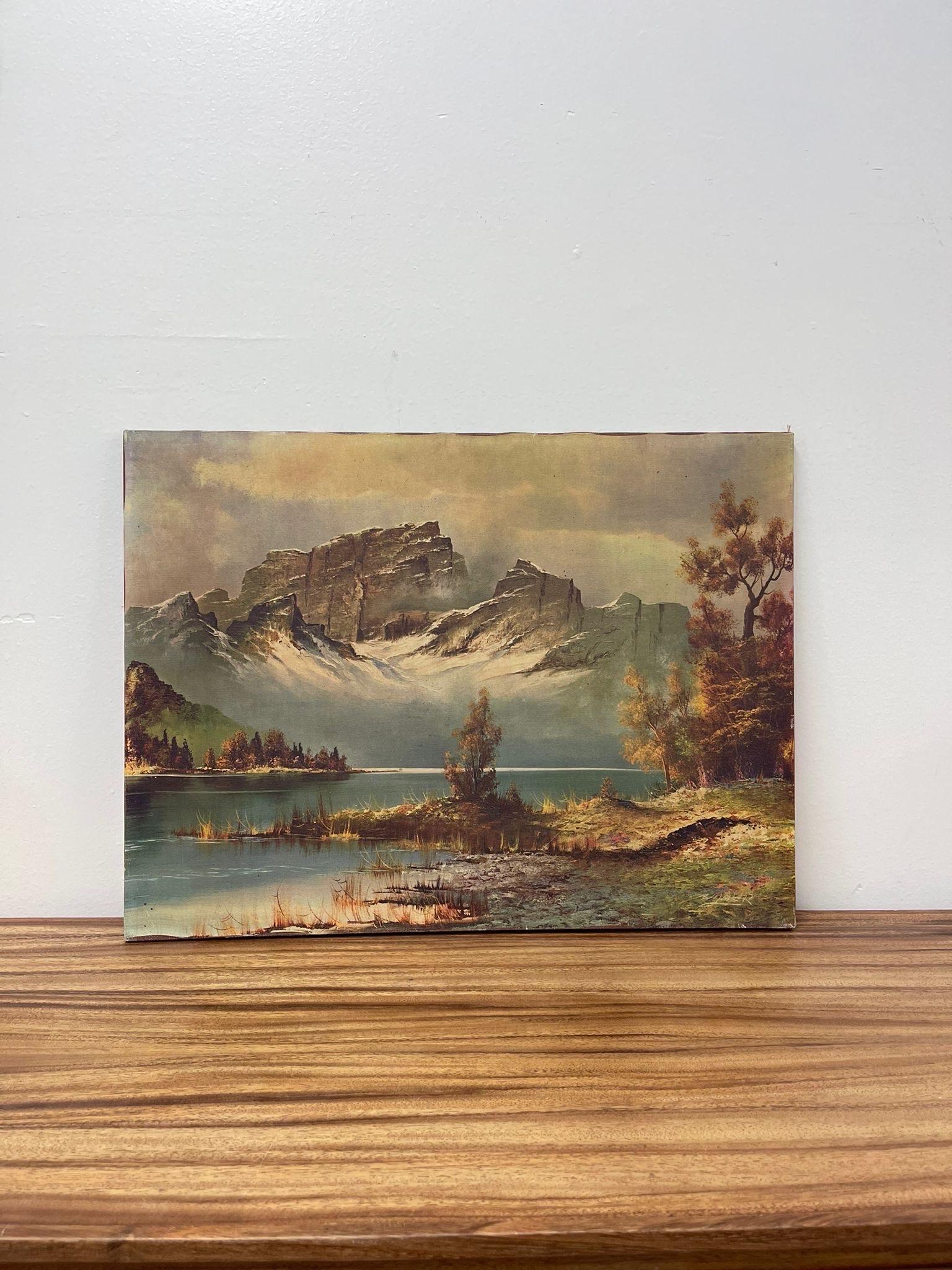 Landscape Print of Mountains over a Lake in the Forest. Beautiful Petina Consistent with Age. Signed in the Lower Corner.Painted Brown Edges to the Canvas. Vintage Condition Consistent with Age as Pictured.

Dimensions. 34 W ; 1/4 D ; 18 H