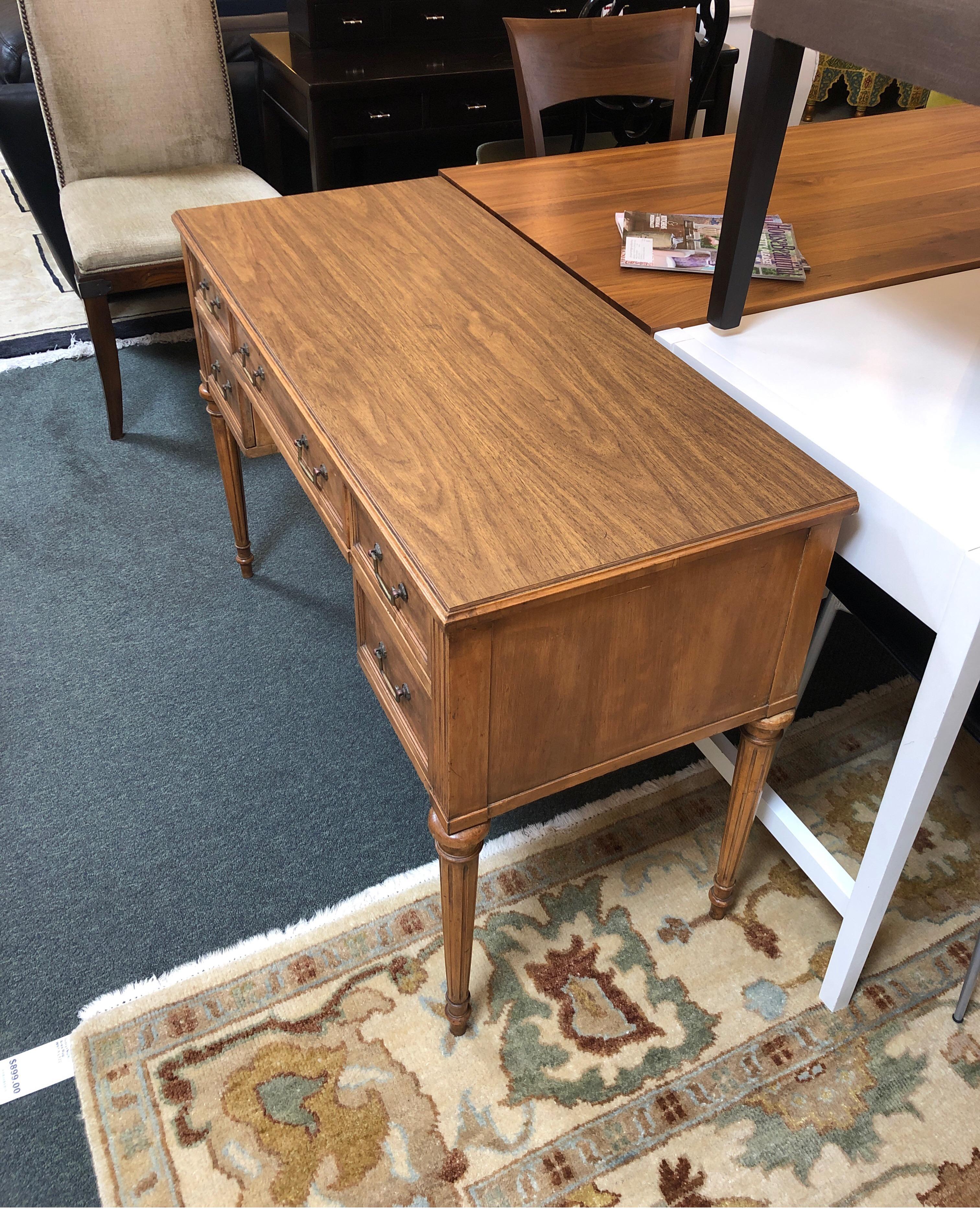 Petite executive desk by Langstrom Furniture of Rockville, IL. Beautifully crafted of solid wood with Classic details, the five drawer desk is wonderfully scaled for tight spaces. Top is rich woodgrain veneer, turned legs and antiqued bronze