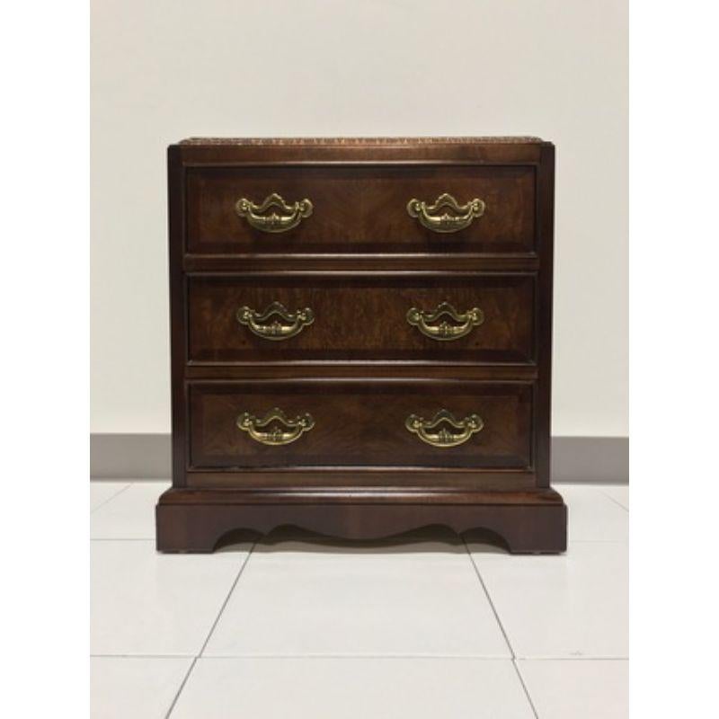 A Chippendale style bedside chest by Lane, of Altavista, Virginia, USA. Walnut and burl walnut with brass hardware. Features three dovetail drawers, side handles and finished on all sides. Made in the late 20th Century. 

Measures: 21.5 W 14 D 22.5