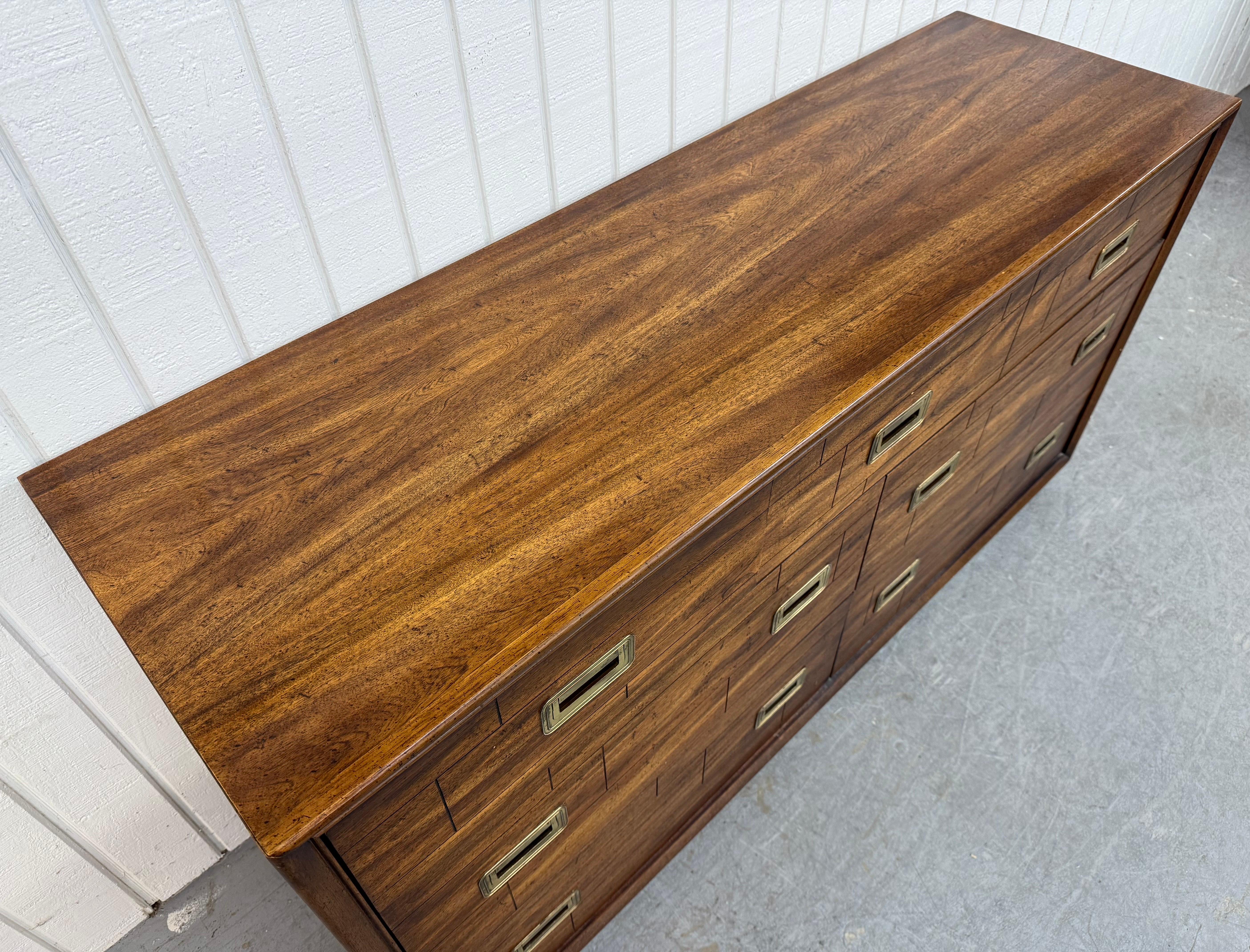 This listing is for a Vintage Lane Campaign Style Walnut Dresser. Featuring a straight line design, six drawers with campaign style brass hardware, short cube feet, and a beautiful walnut finish. This is an exceptional combination of quality and
