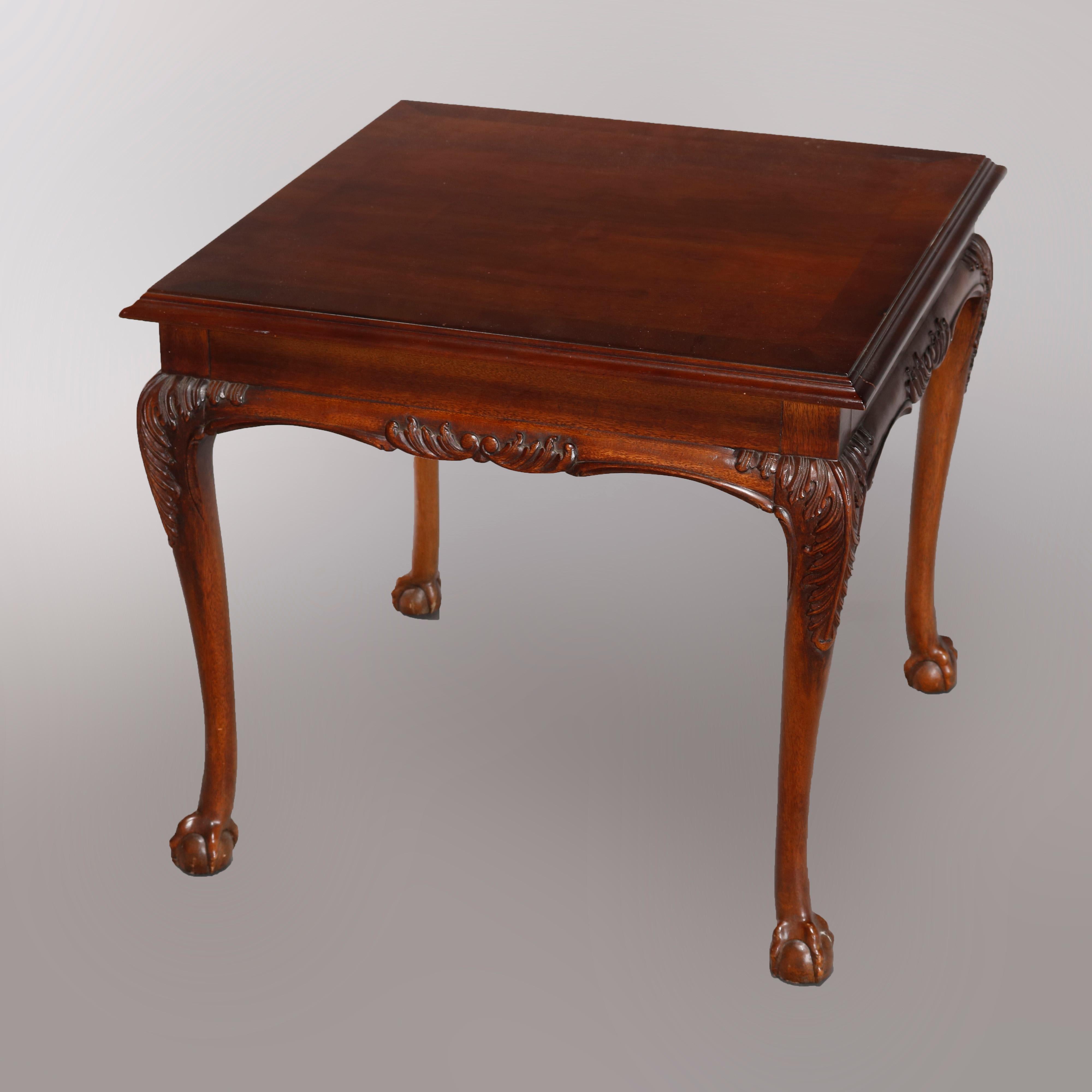 A vintage Chippendale style side table by Lane Furniture Co. offers mahogany construction with square top having shaped skirt with carved foliate decoration, raised on cabriole legs with fern or acanthus carved knees and terminating in claw and ball