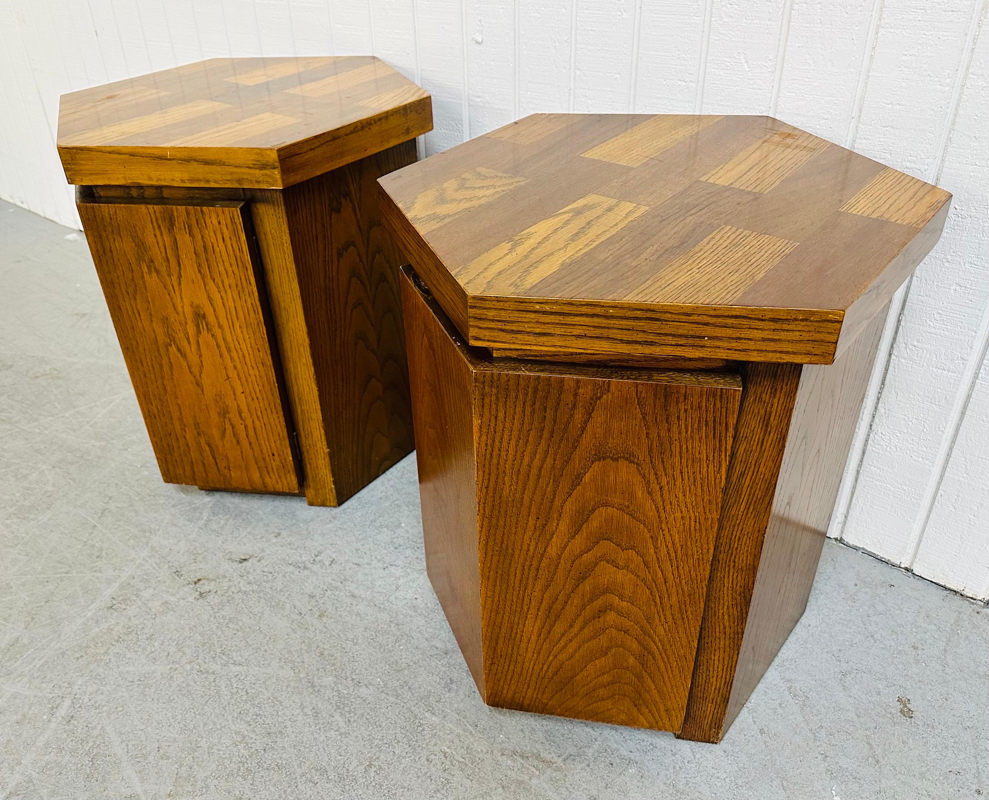 This listing is for a pair of vintage Lane Hexagonal Oak Side Tables. Featuring a hexagonal design, a single door that opens up to storage space, and a beautiful oak finish. This is an exceptional combination of quality and design by Lane!