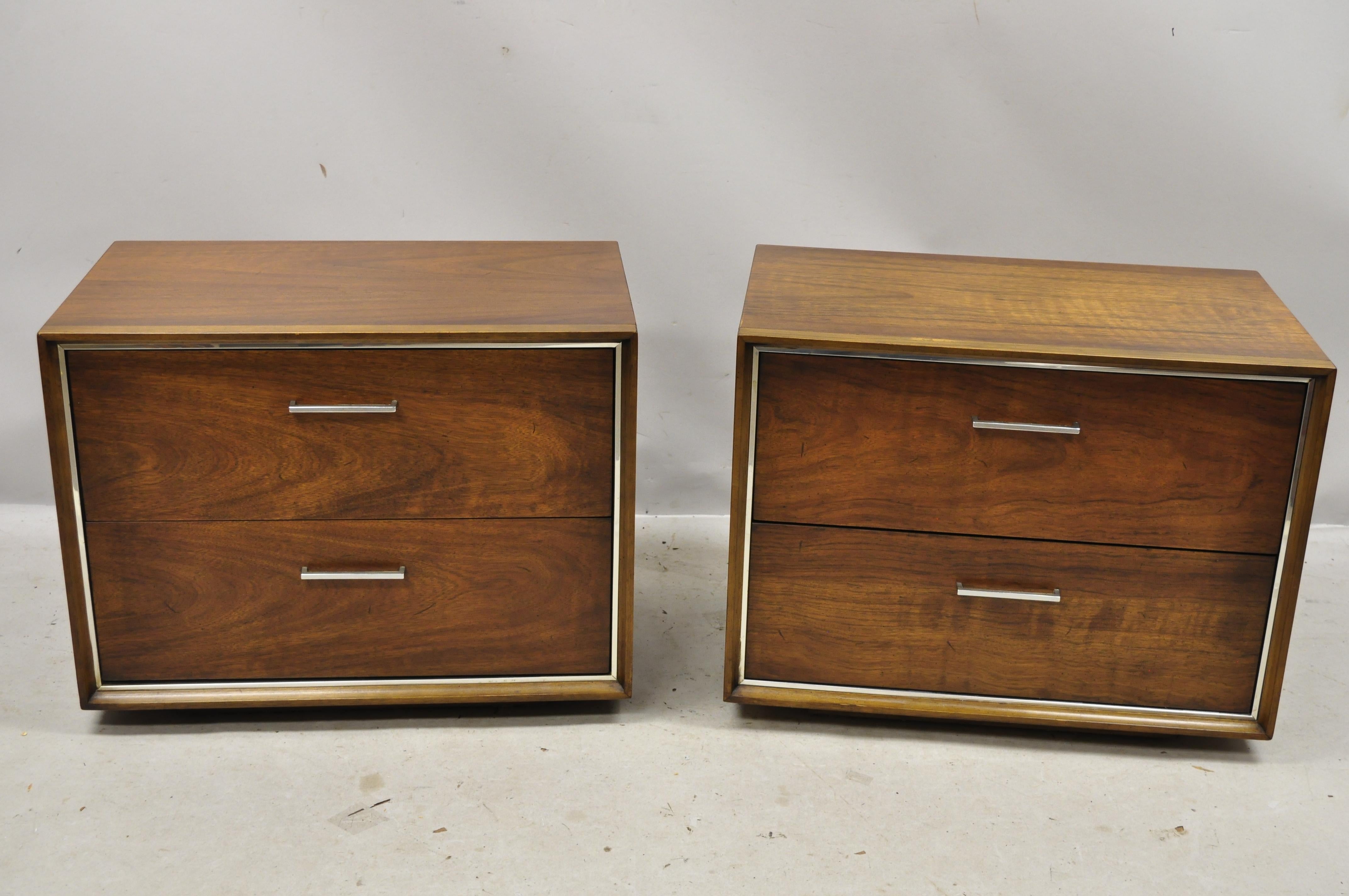Vintage lane Mid-Century Modern walnut chrome trim 2-drawer nightstand - a pair. Item features chrome trim and handles, beautiful wood grain, original stamp, 2 dovetailed drawers, clean modernist lines, circa mid-20th century. Measurements: 20