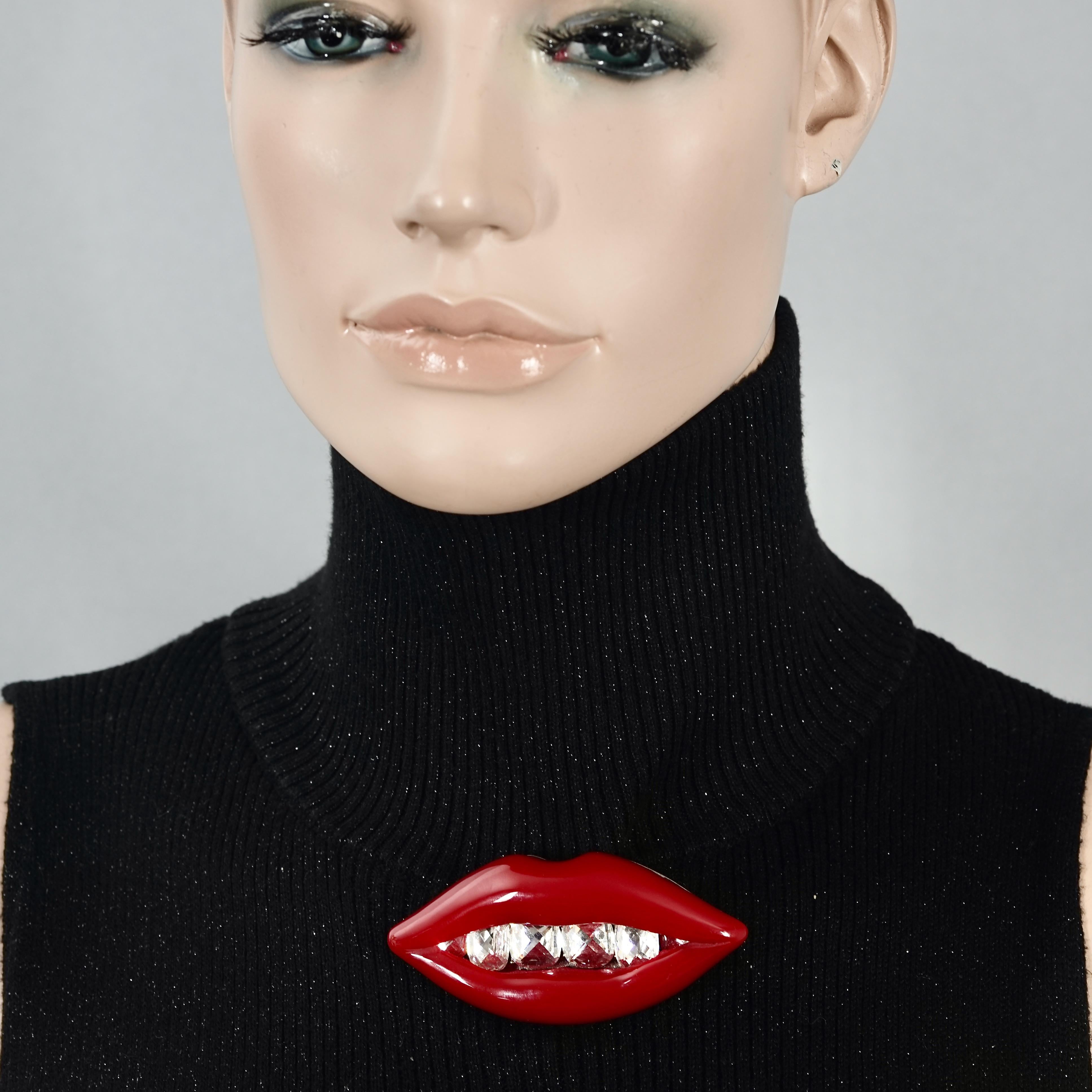 Vintage LANVIN Mouth Resin Crystal Brooch	

Measurements:
Height: 1.49 inches (3.8 cm)
Width: 3.19 inches (8.1 cm)

Features:
- 100% Authentic LANVIN.
- Shiny red resin mouth with crystal teeth embellishment.
- The signature plaque at the back has