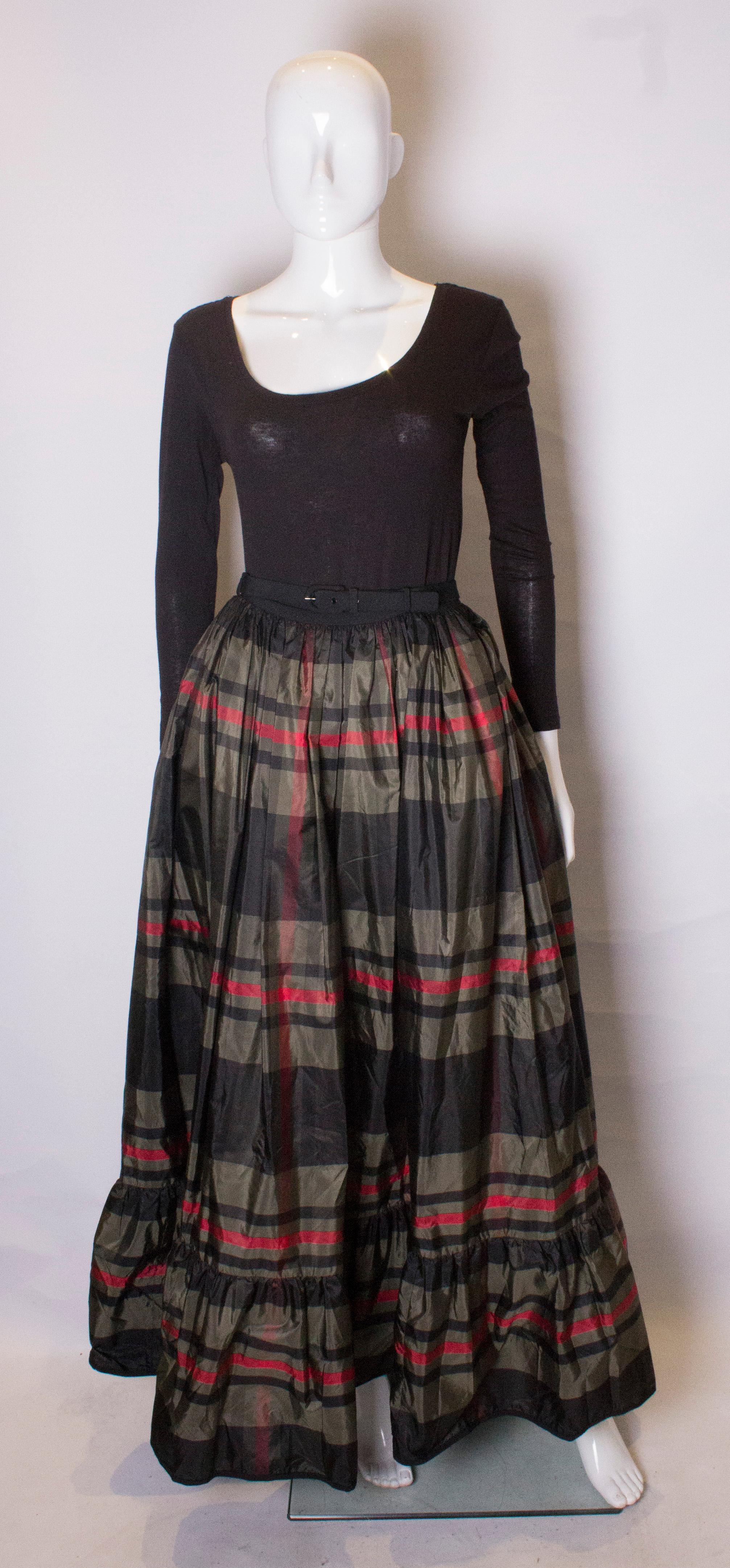 A great skirt for the festive season. This vintage silk Lanvin skirt , has a wonderful swish to it, with net under the frill to give it defnition. It has an olive green background with red and black check design. It has a matching