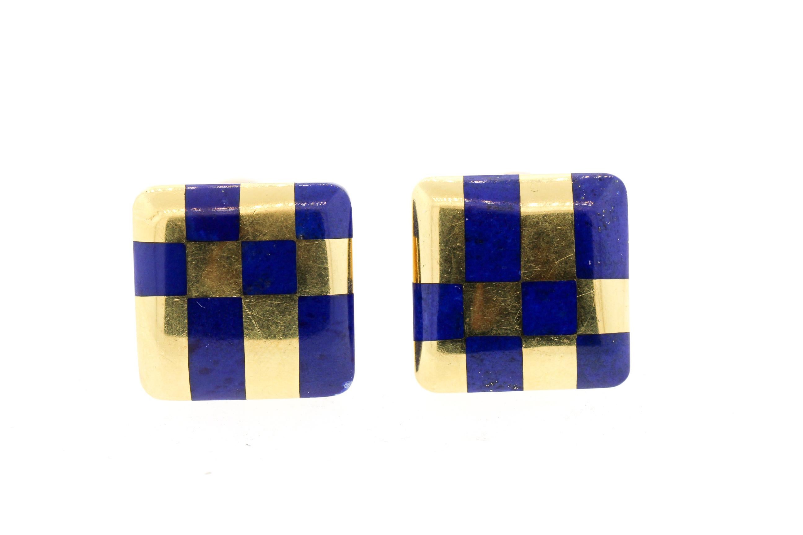 Classic inlaid lapis and 18k yellow gold checker earrings designed by Angela Cummings and retailed by Tiffany & Co. circa 1980. These earrings are meant to be opposites of each other and are bold in design and color. The earrings are marked Tiffany