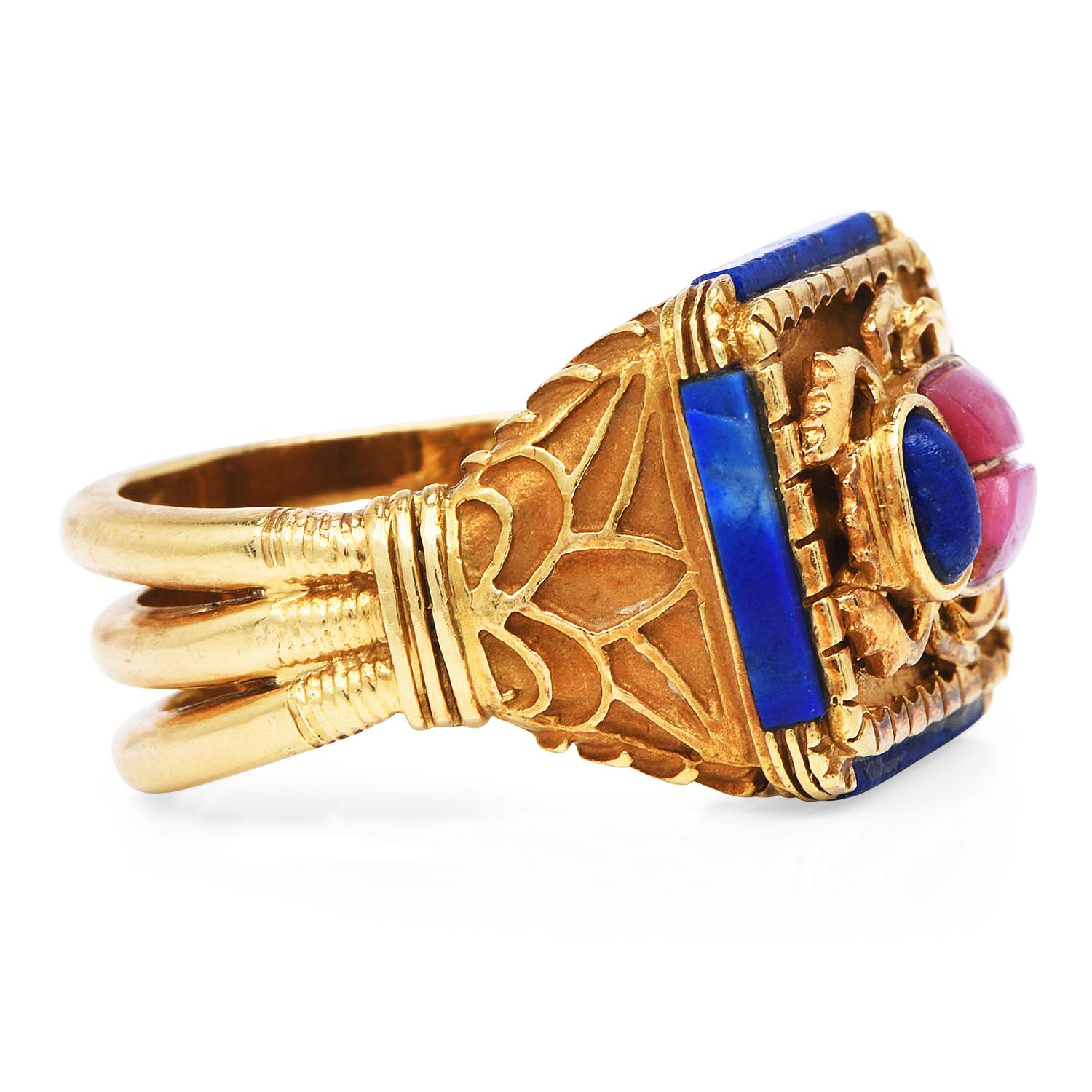 A Vintage ring with a mystical intricate design, centered by an Egyptian scarab and sided by Fleur de Lis accents.

Create an exceptional look with this prominent ring!

The center scarab design has two cabochon rhodochrosite gemstones, measuring