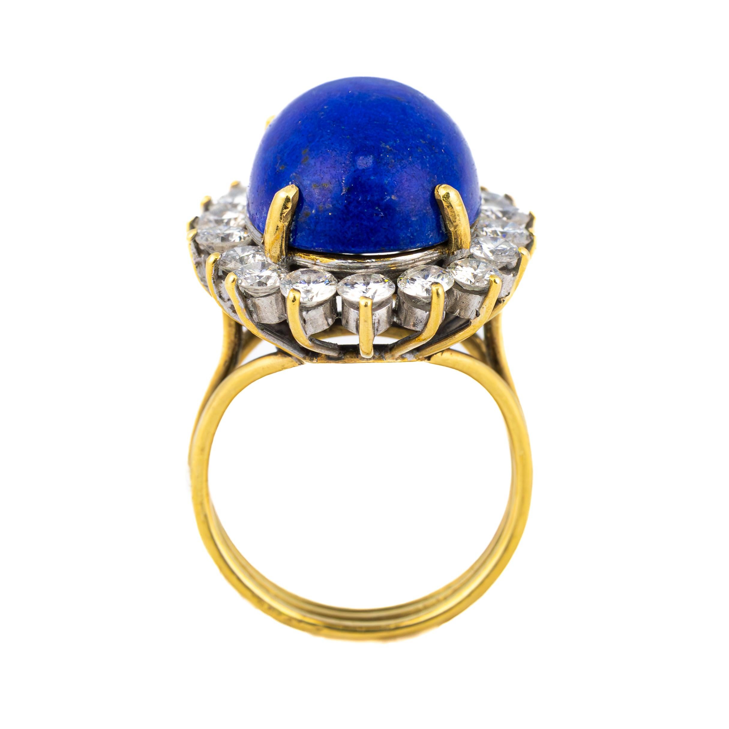 Vintage Lapis Lazuli and Diamond Halo Ring

A striking vintage ring centered around a deep celestial blue lapis lazuli cabochon, encircled by a halo of radiant diamonds, set in an elegant yellow gold mounting. The lapis lazuli's rich hue is