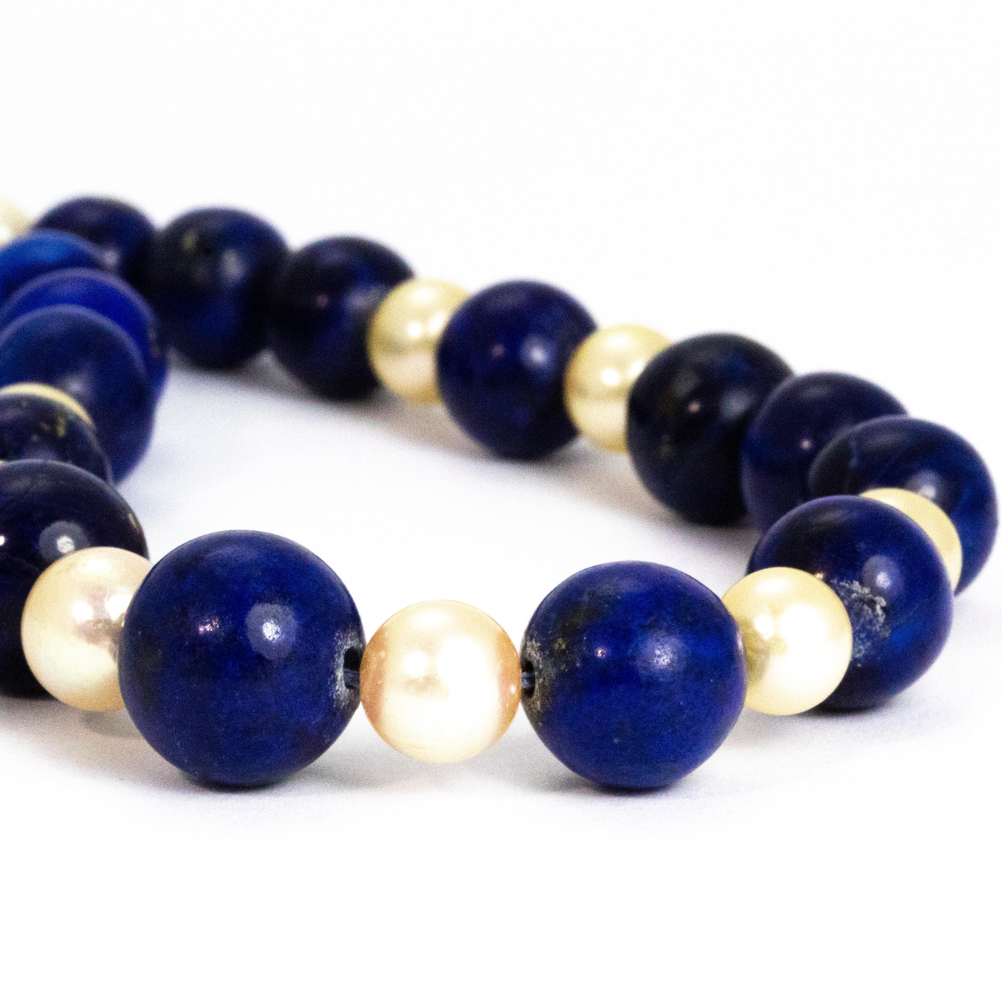 The blue of the gorgeous lapis stone beads really pop next to the glossy pearl spacers. There is no question that the bright blue beads are the main attraction of this necklace. They are graduated in size with the biggest beads at the centre getting