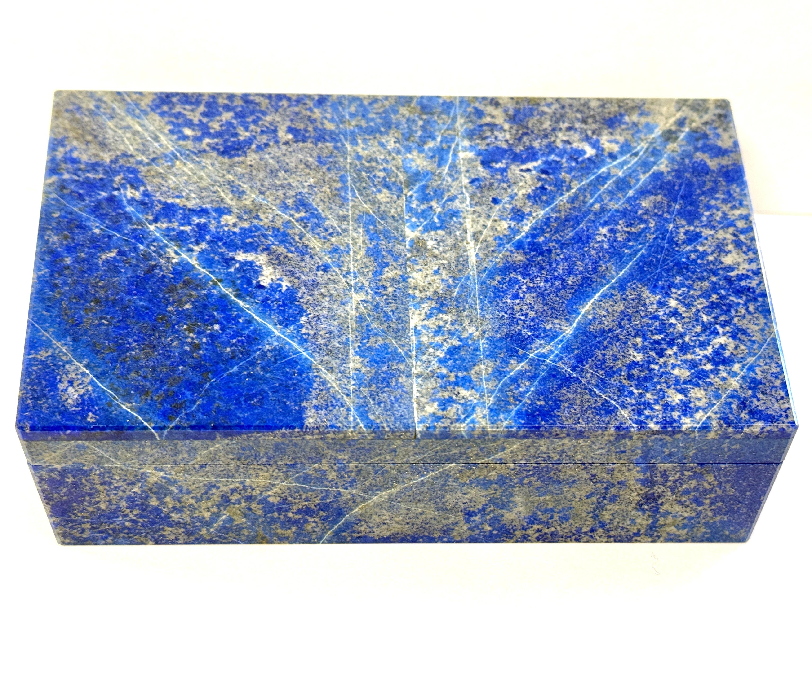 A stunning Lapis Lazuli box out an an estate collection of 4 rare specimen boxes. This box has beautifully graining and great color. It still has the remnants of a label on the bottom. It has a Brass inner hinge. It’s lined with Alabaster I believe.