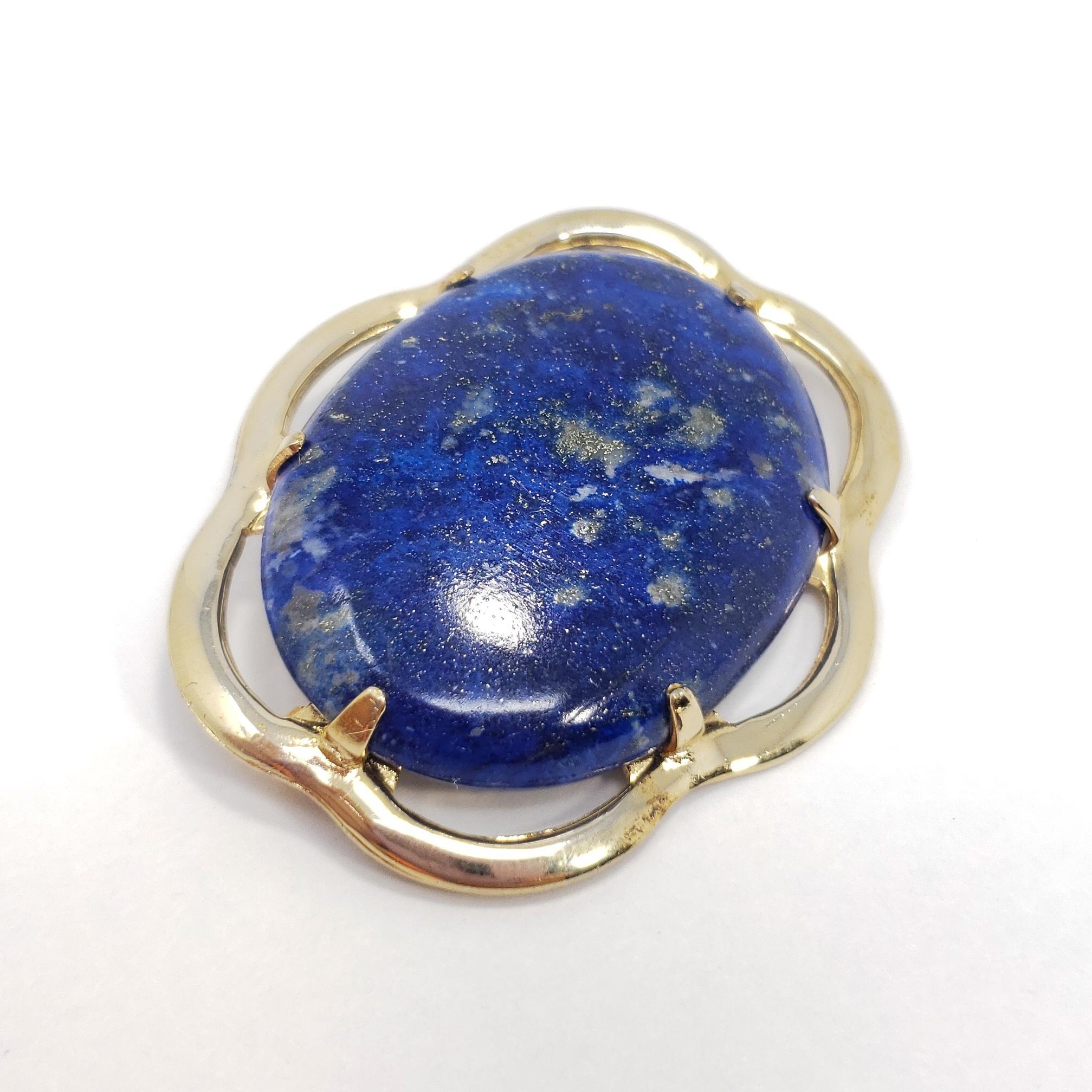 A sophisticated accessory! This pin-brooch features a single lapis lazuli cabochon, prong-set in an elegant, gold-filled, open-back, setting.