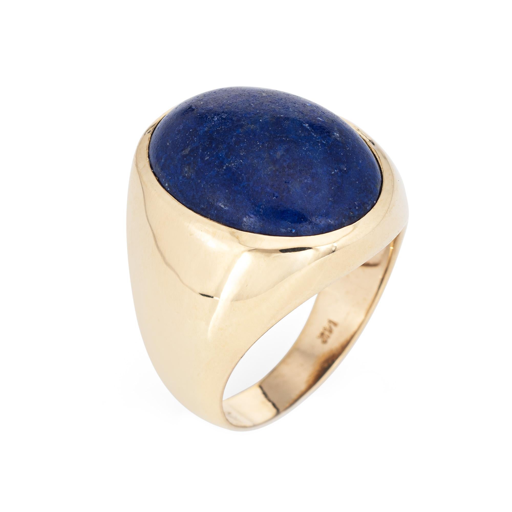 Stylish vintage lapis lazuli signet ring (circa 1960s to 1970s) crafted in 14 karat yellow gold. 

Cabochon cut lapis lazuli measures 20mm x 15mm (estimated at 16 carats). The lapis lazuli is in very good condition and free of cracks or chips. 

The