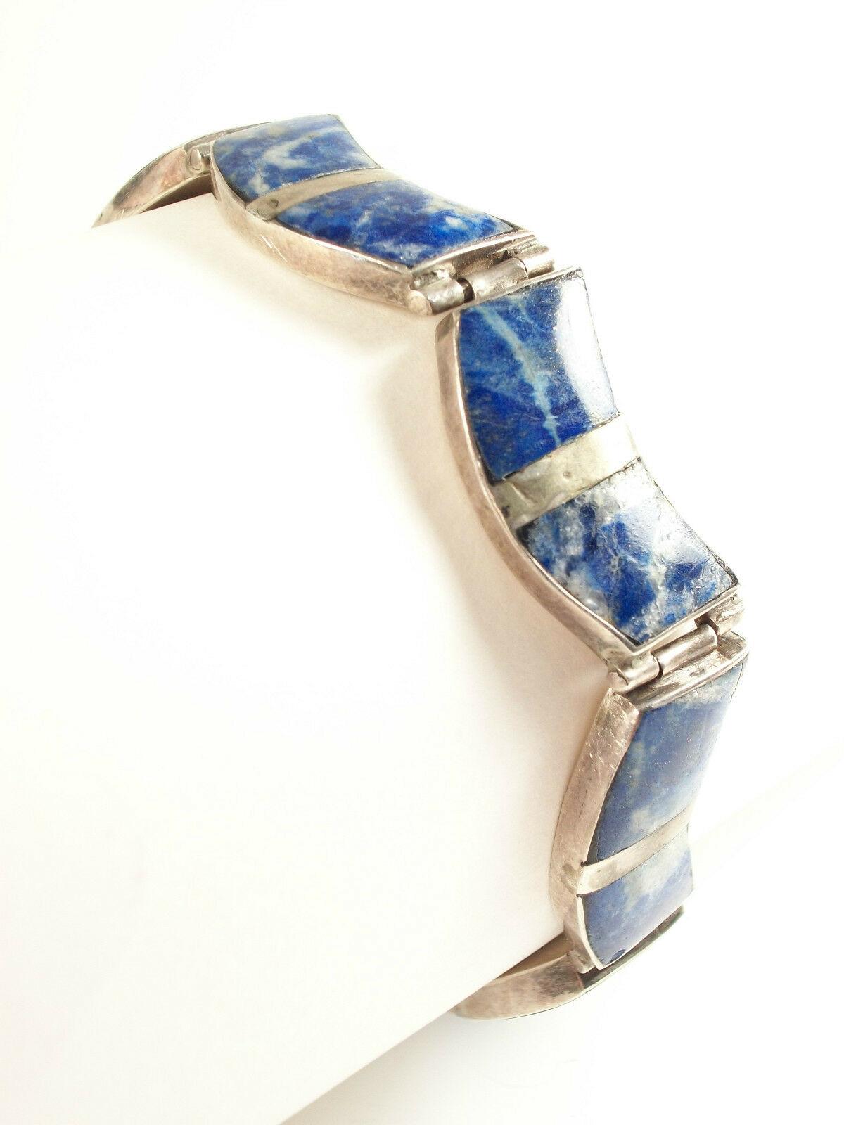 Vintage - extraordinary quality and design silver bracelet - set with panels of lapis lazuli - scalloped/hinged links with safety catch and closure - stamped on the back - PLATA 980 (between sterling silver and fine silver) - Mexico - mid 20th