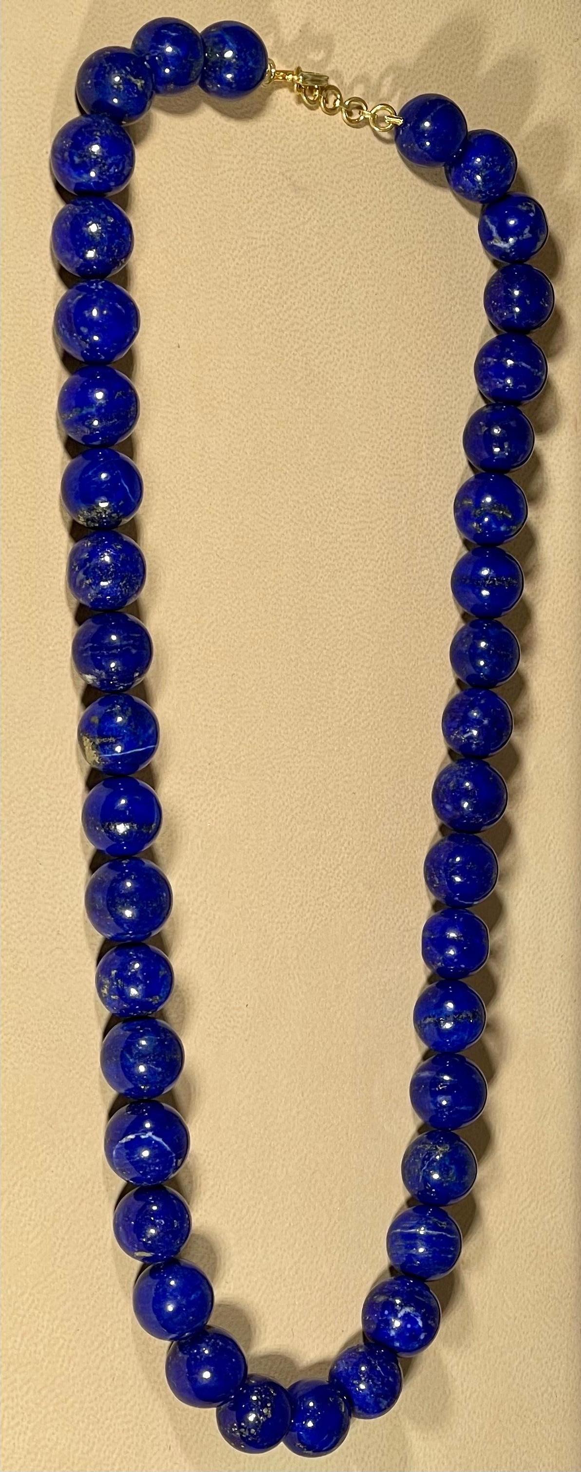 Vintage Lapis Lazuli Single Strand Necklace With 14 Karat Yellow Gold  adjustable clasp
This marvelous vintage Lapis Lazuli  necklace features 1 row of luscious  Beads
(measuring approximately average  12-12.6 mm)  
strand is 20 inches long
There