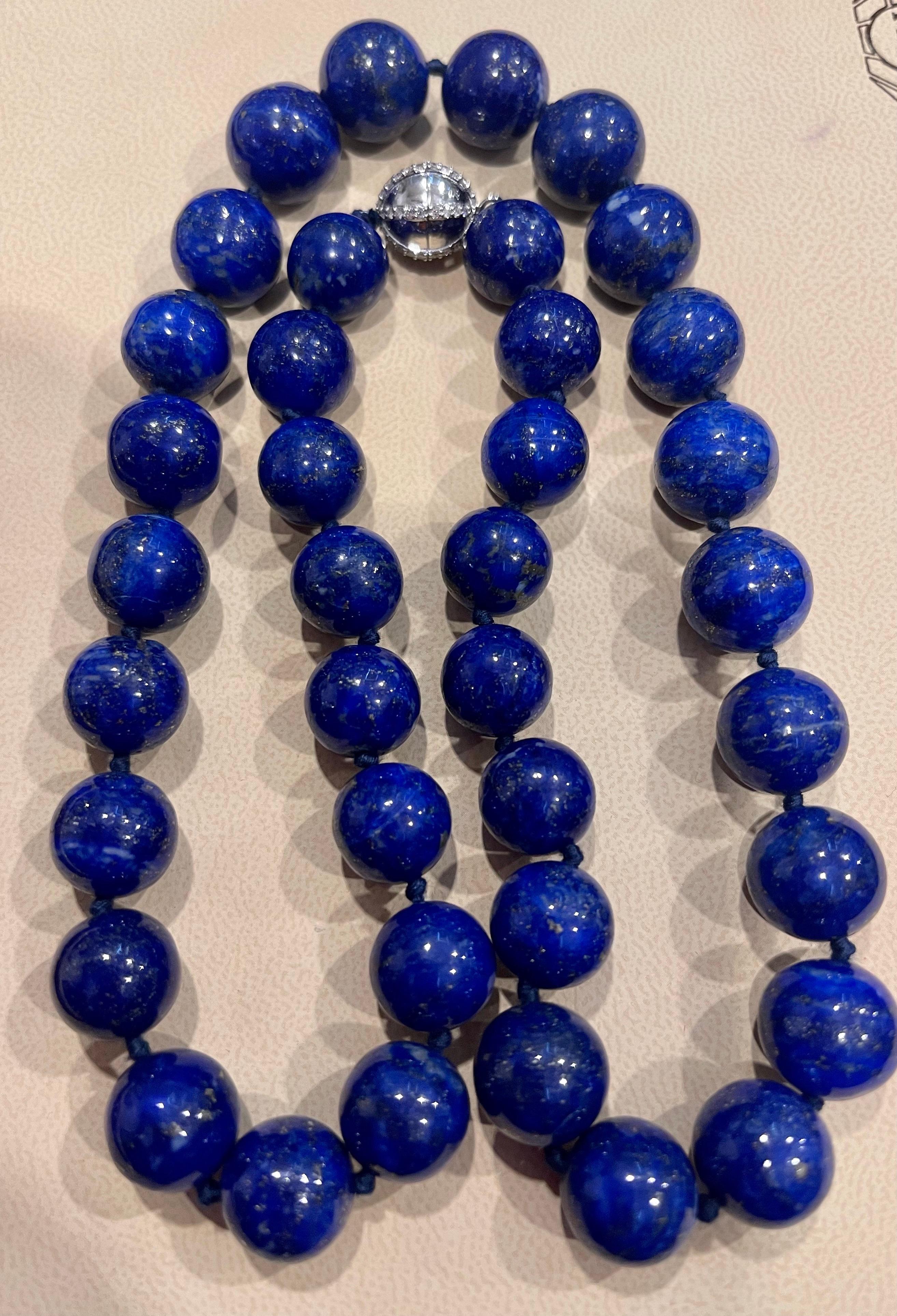 Vintage Lapis Lazuli Single Strand Necklace  with 0.8 Carat Diamond Ball  Clasp in 14 Karat  White Gold
This marvelous vintage Lapis Lazuli  necklace features 1 row of luscious  huge Beads
(measuring approximately from 15 MM to 13 MM)  . It is a