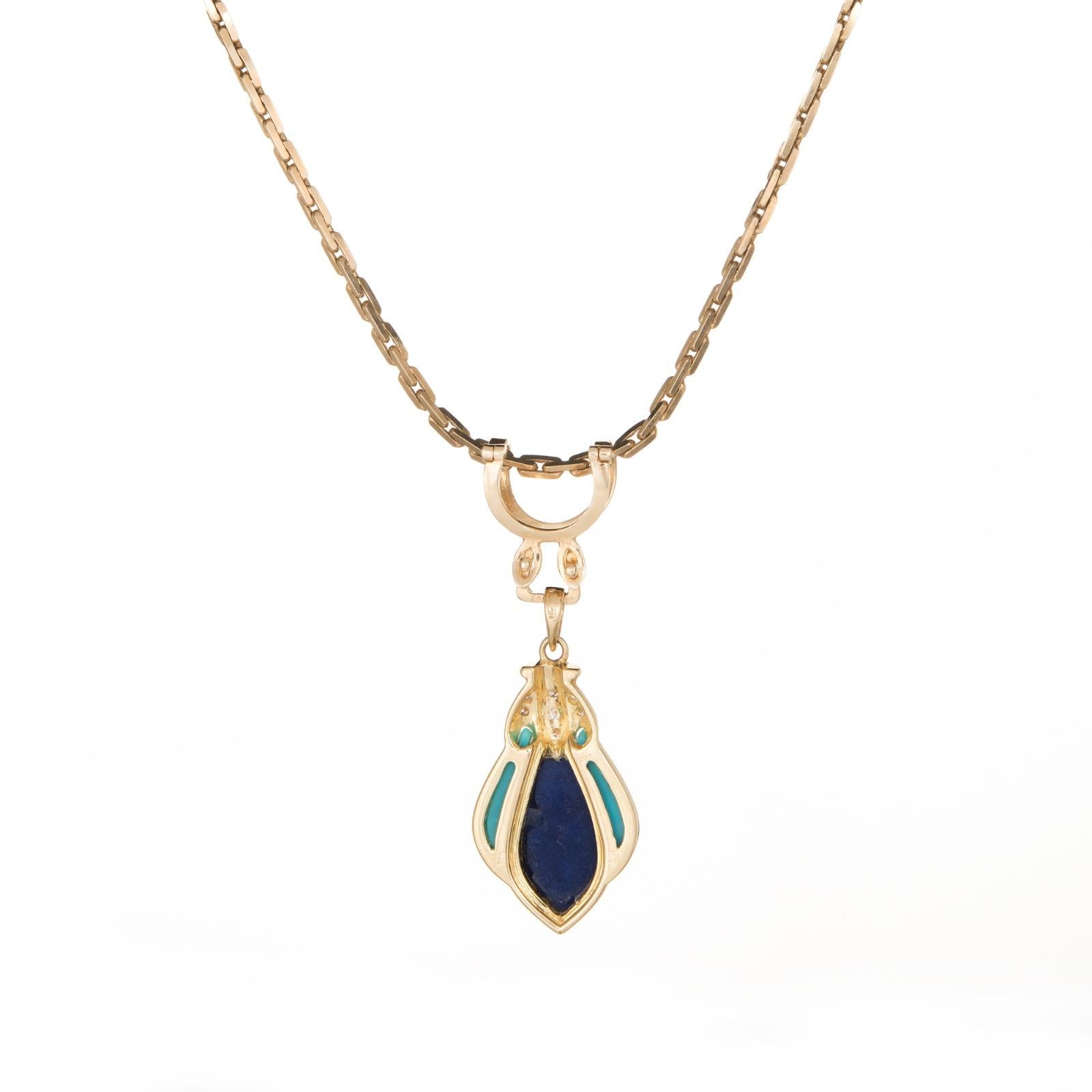 Finely detailed vintage diamond, turquoise & lapis lazuli necklace crafted in 14 karat yellow gold (circa 1960s to 1970s). 

Cabochon cut lapis lazuli and turquoise is inlaid into the mount, accented with an estimated 0.08 carats of diamonds