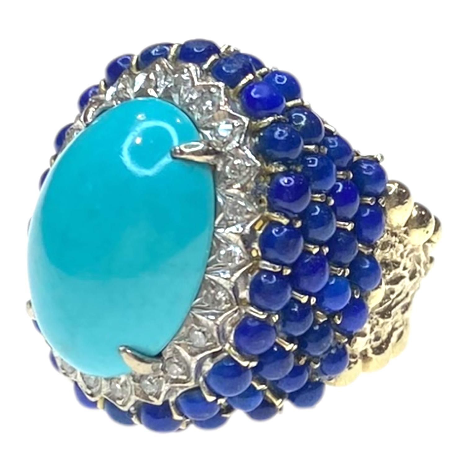 Vintage cocktail ring crafted in 14k yellow gold, featuring a striking cabochon-cut turquoise centerpiece. The vibrant blue stone is surrounded by a halo of single-cut white diamonds, enhancing its bold presence. An outer layer of deep blue lapis