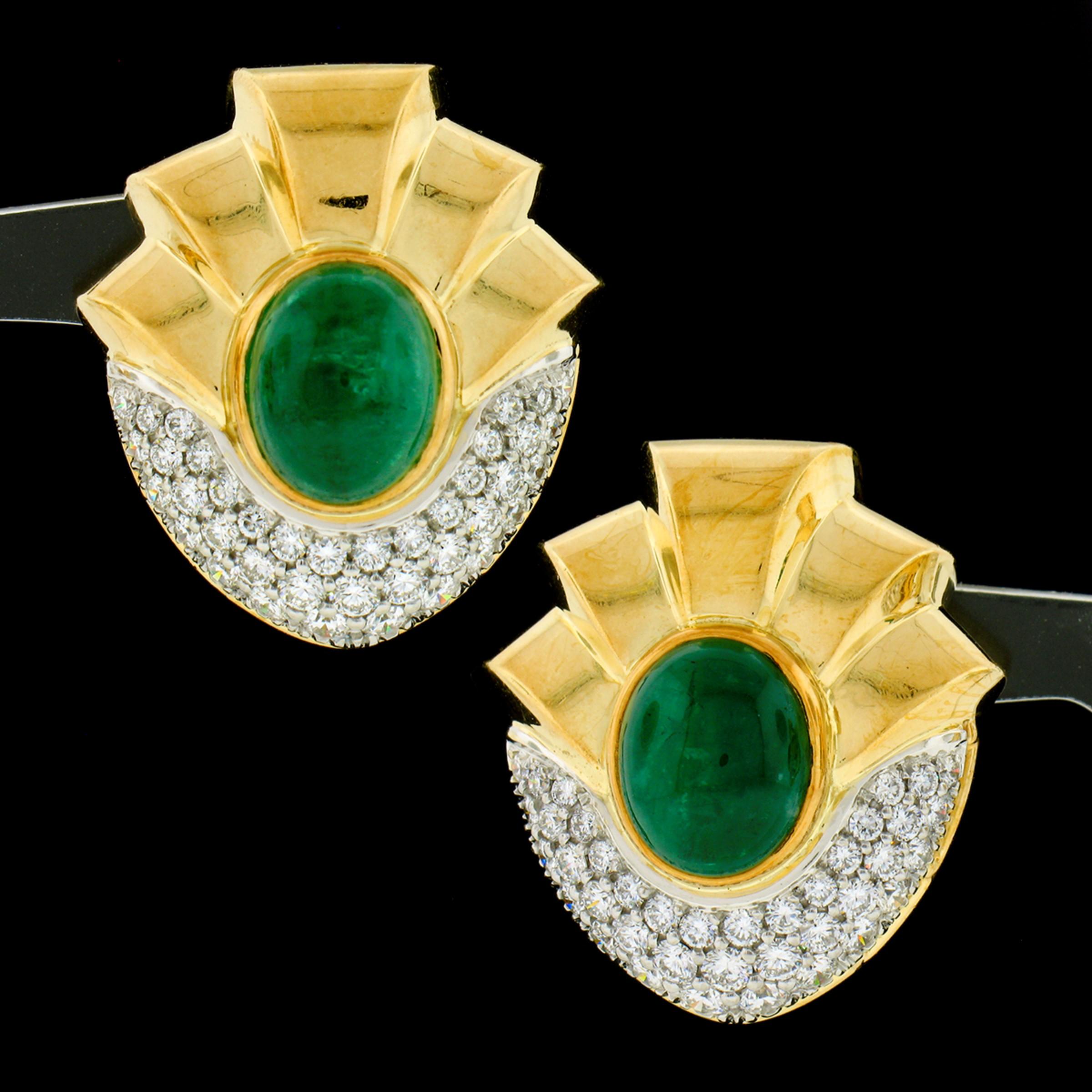 This magnificent vintage pair of natural emerald and diamond statement earrings was crafted from solid 18k yellow gold. The earrings feature a pair of beautiful, GIA certified, oval cabochon cut emeralds that are perfectly bezel set at the center of