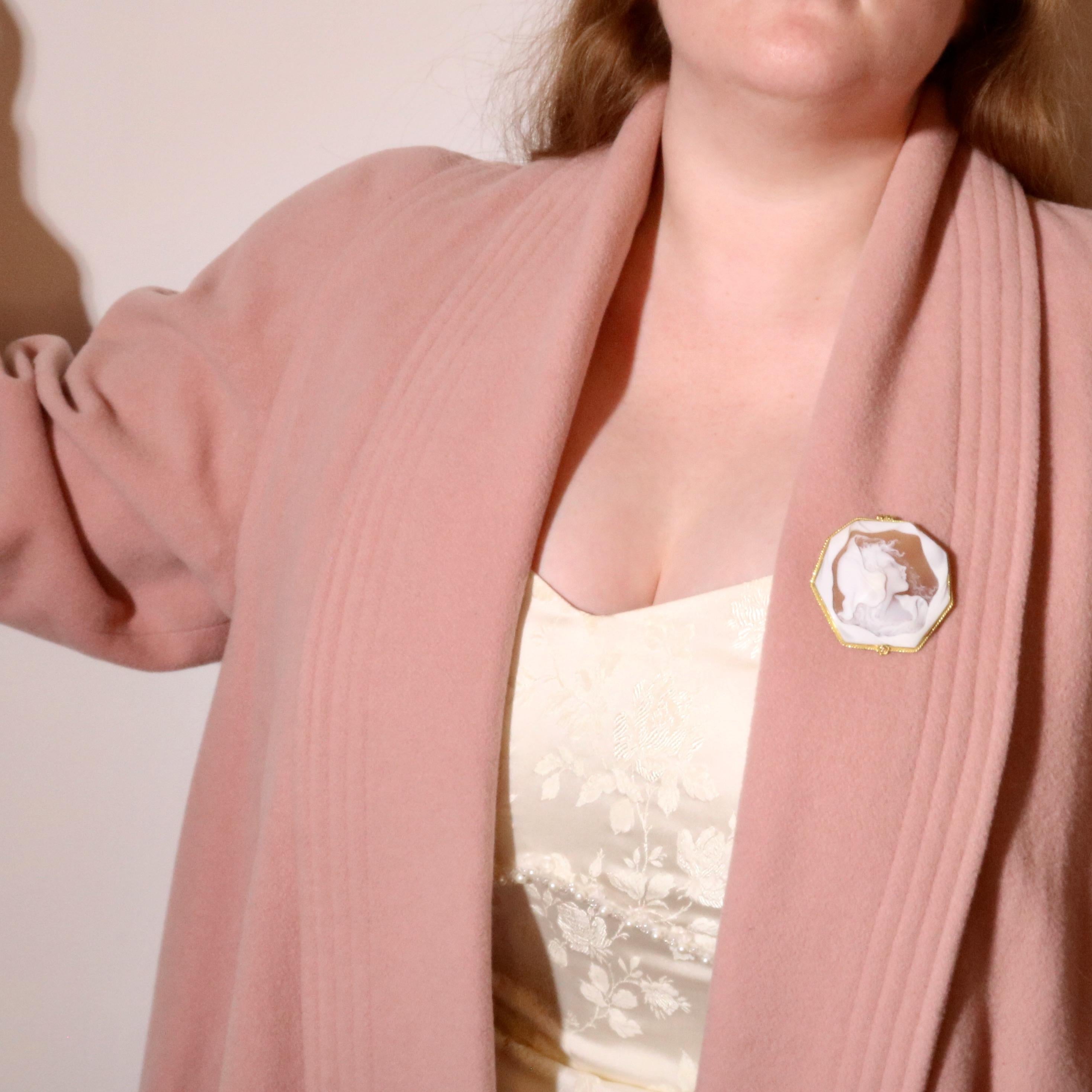 A yellow gold and carved shell cameo pendant, comprising one octagonal panel of carved shell, set within an 18 karat yellow gold frame, with 18 karat yellow gold fittings. 

This statement pendant is large in size, sure to catch many an eye. The
