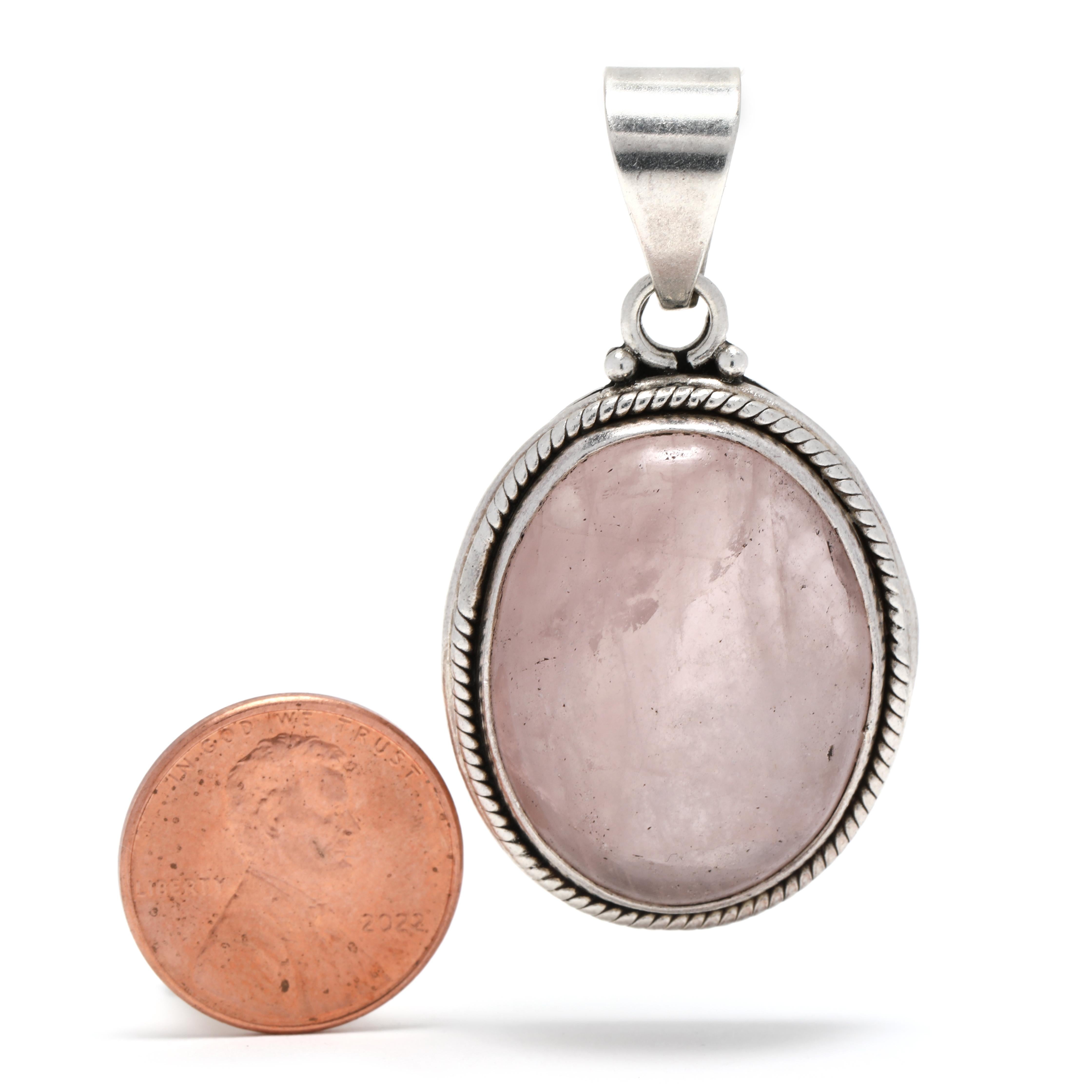 This stunning vintage large rose quartz pendant is a show stopper! Crafted in sterling silver, the pendant features a beautiful 35ct rose quartz stone, bezel set in the center. The pink stone has a gorgeous color and clarity that will look amazing