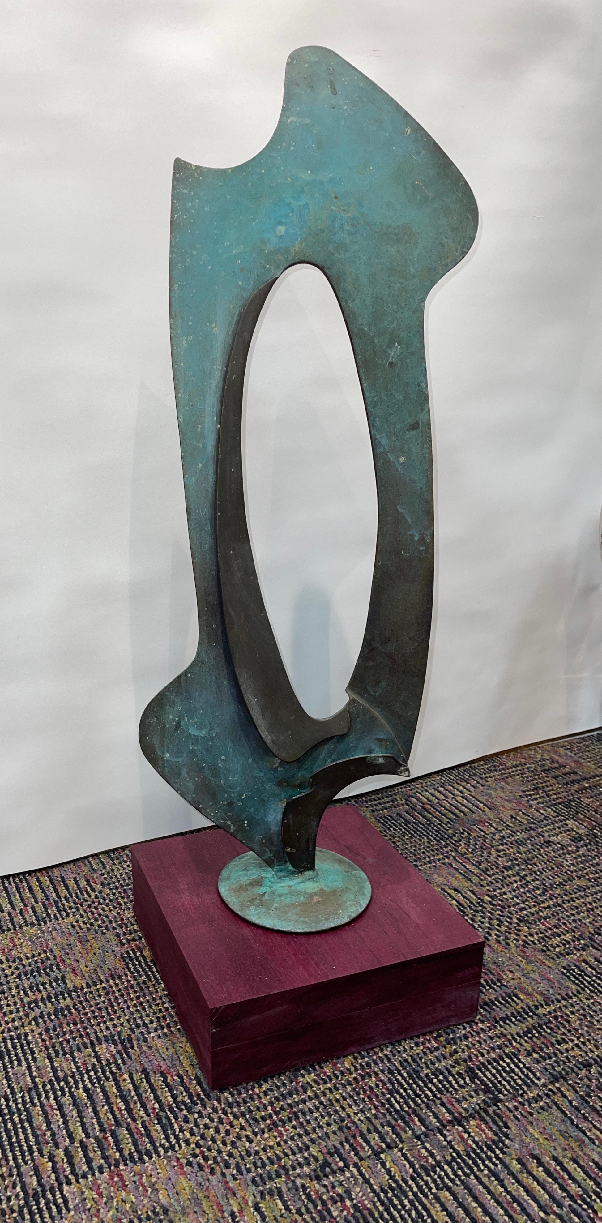 Beautiful vintage abstract bronze with great patina. Newly mounted on a purple heart base. Not signed that we can find. Great flow and form. Greenish patina from age and weathering.