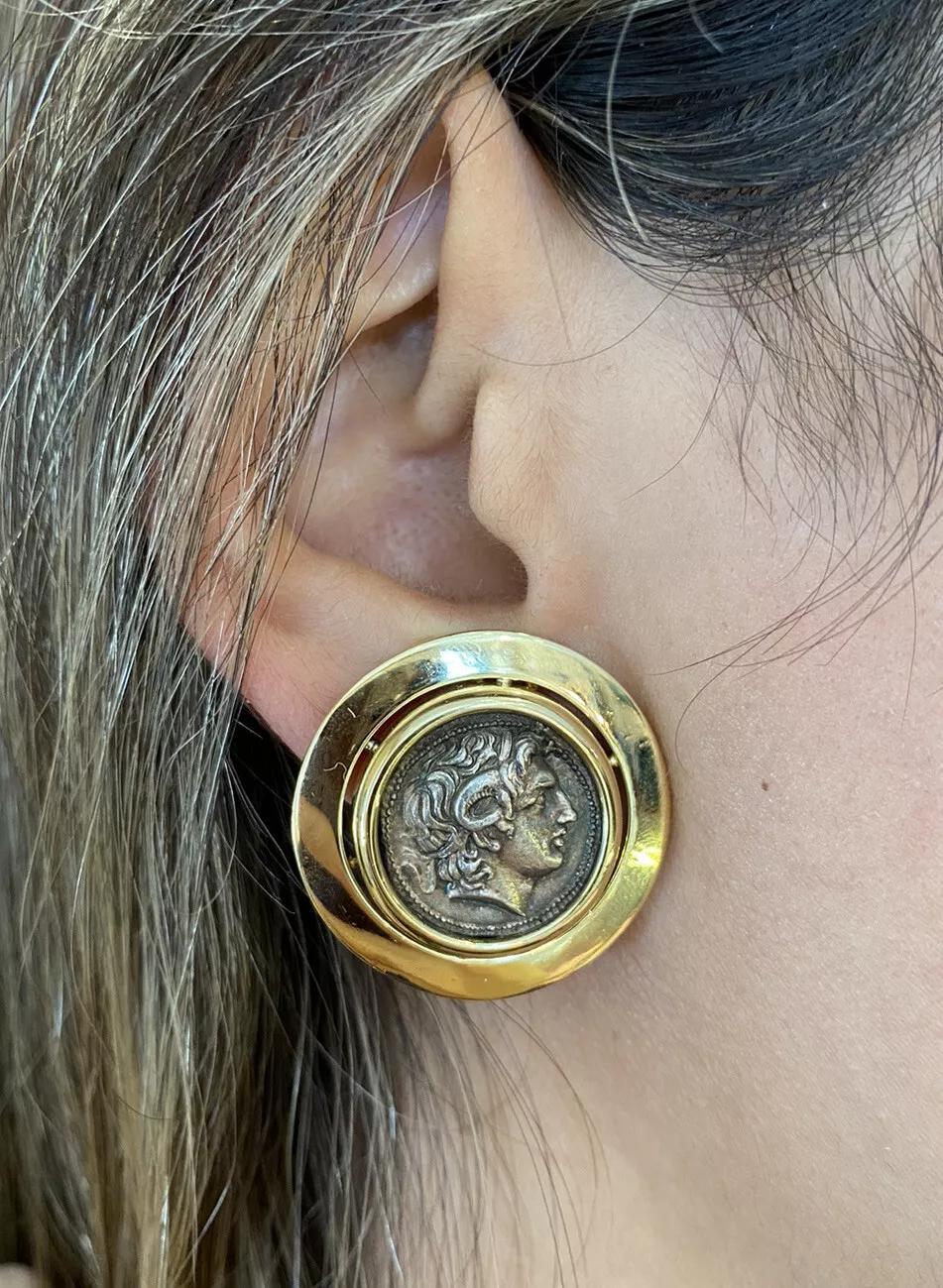 Vintage Large Coin Button Earrings in 18k Yellow Gold

Vintage Large Coin Button Earrings feature a pair of large Ancient Coins Bezel set in High Polished 18k Yellow Gold. The earrings are secured by Omega back clips without posts (posts can be