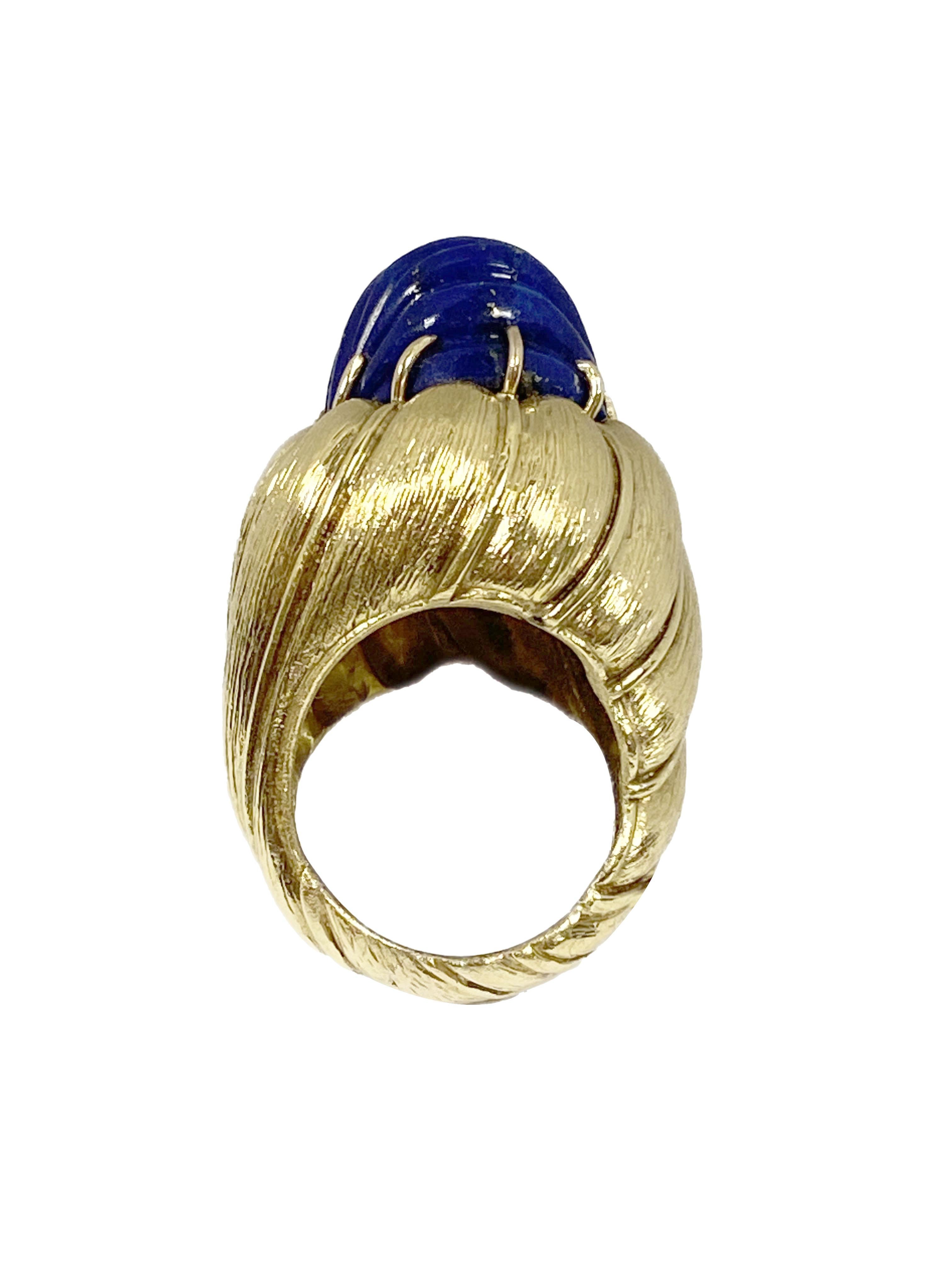 Circa 1970 18K Yellow Gold statement Ring, the top measures 1 inch in length X 7/8 inch, set with a Domed Scalloped Lapis Lazulli. Weighing 33.6 Grams and is a finger size 6. 
