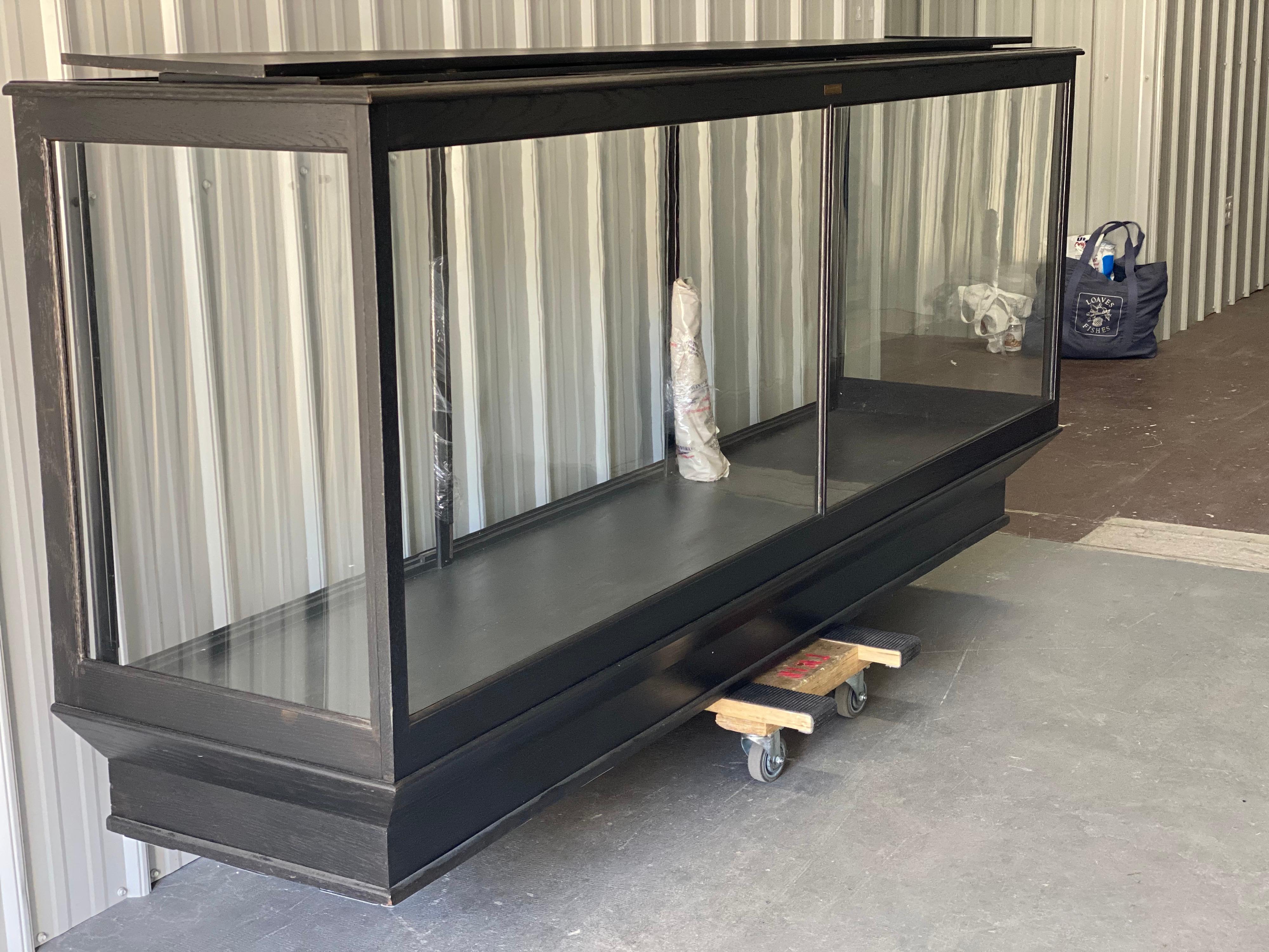 Vintage large scale black stained oak & glass shop display case/cabinet by Columbus Showcases
This is a fantastic display with plenty of display shelving and perfect height for viewing. The frame is crafted in oak and more recently refinished in a