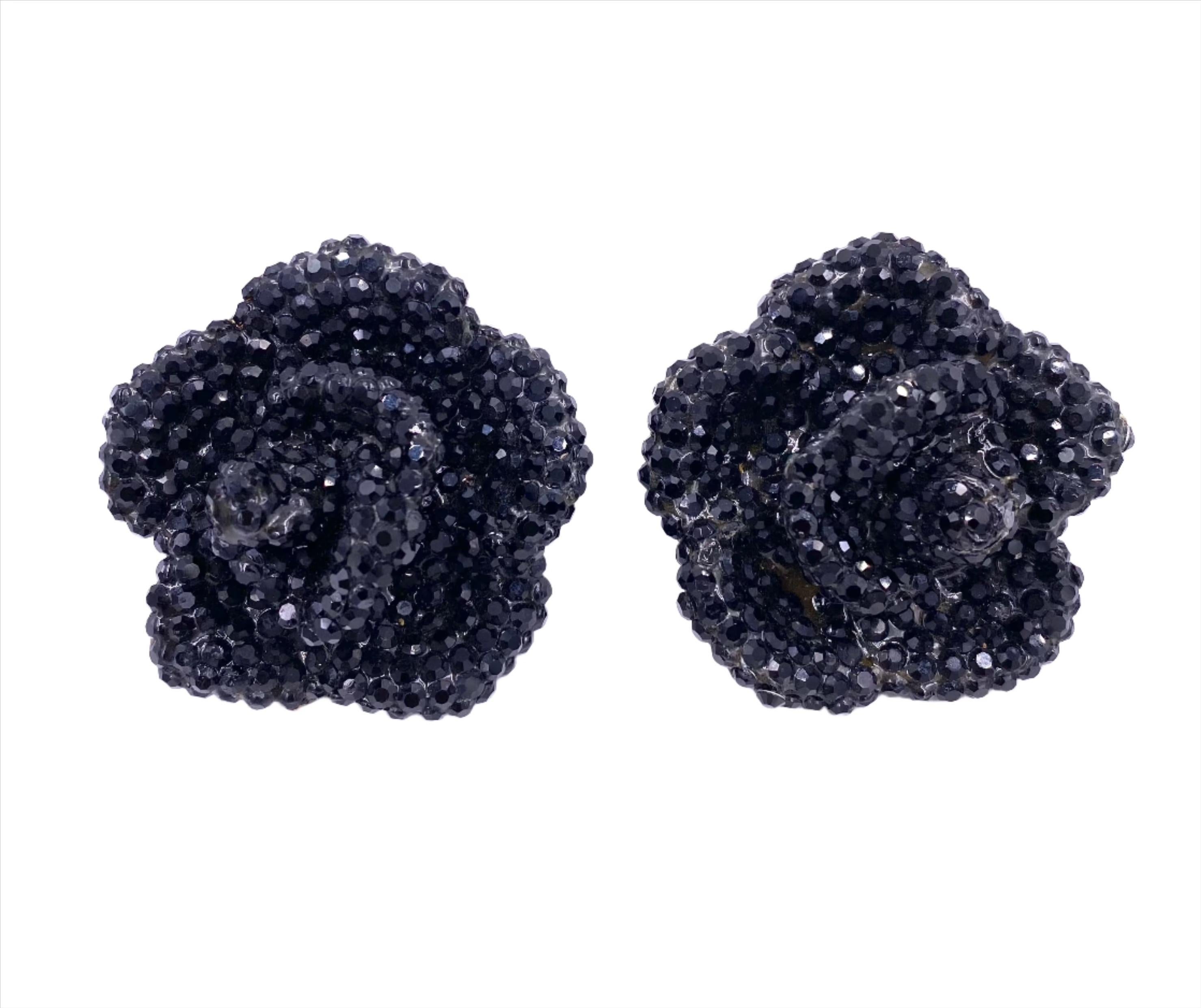 Indulge in luxury with our Vintage Large Black Stone Rose Clip-On Earrings. These elegant earrings feature stunning black rhinestone roses, perfect for special occasions. Stand out and add a touch of glamour with these beautifully encrusted