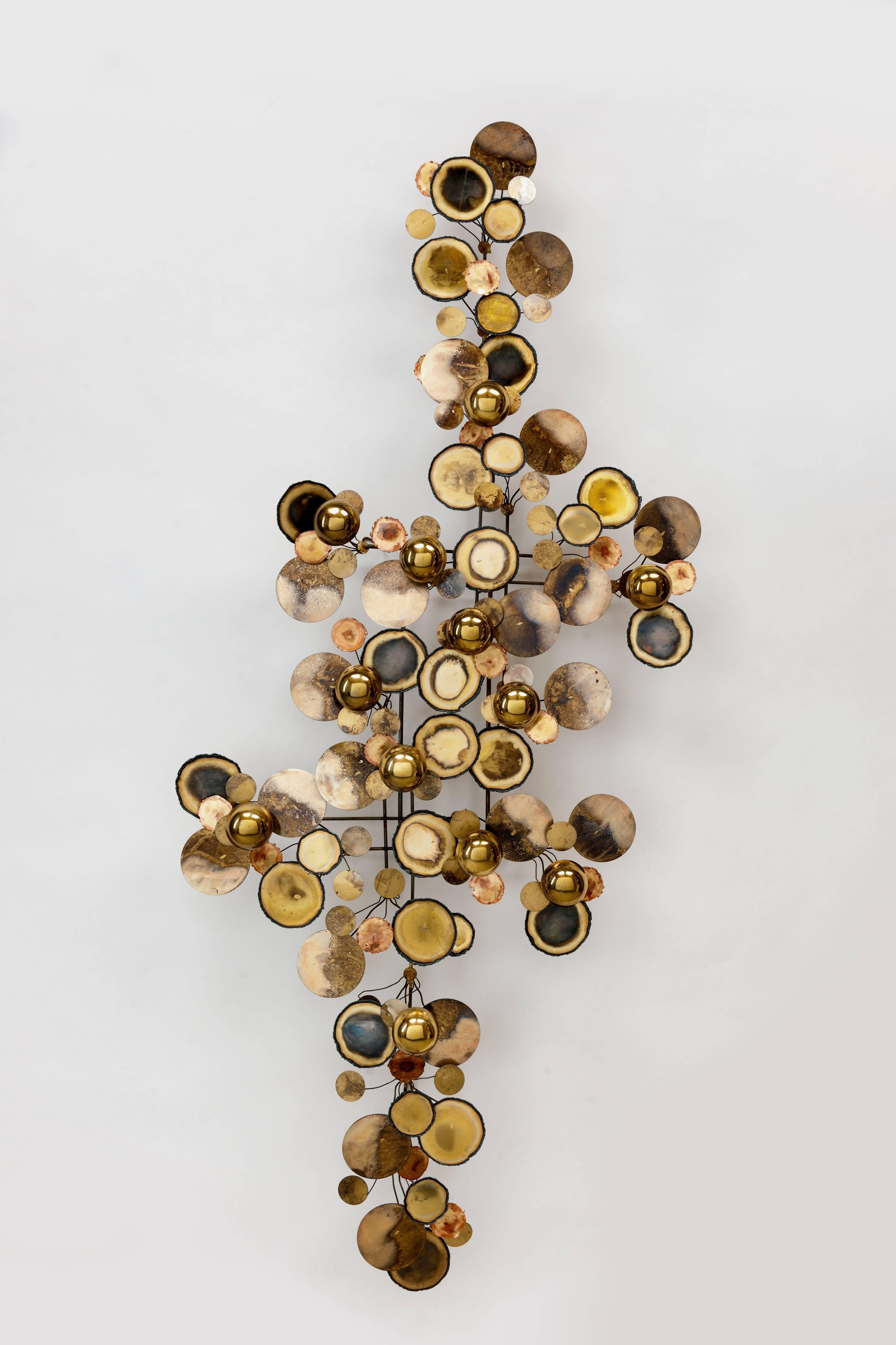 Iconic 'Raindrops' wall sculpture by C. Jere / Artisan House, in brass execution.
Abstract metal wall sculpture of torched edge disc's and half spheres made originally between 1965-1979. 
This object is magnificent condition, is fully signed