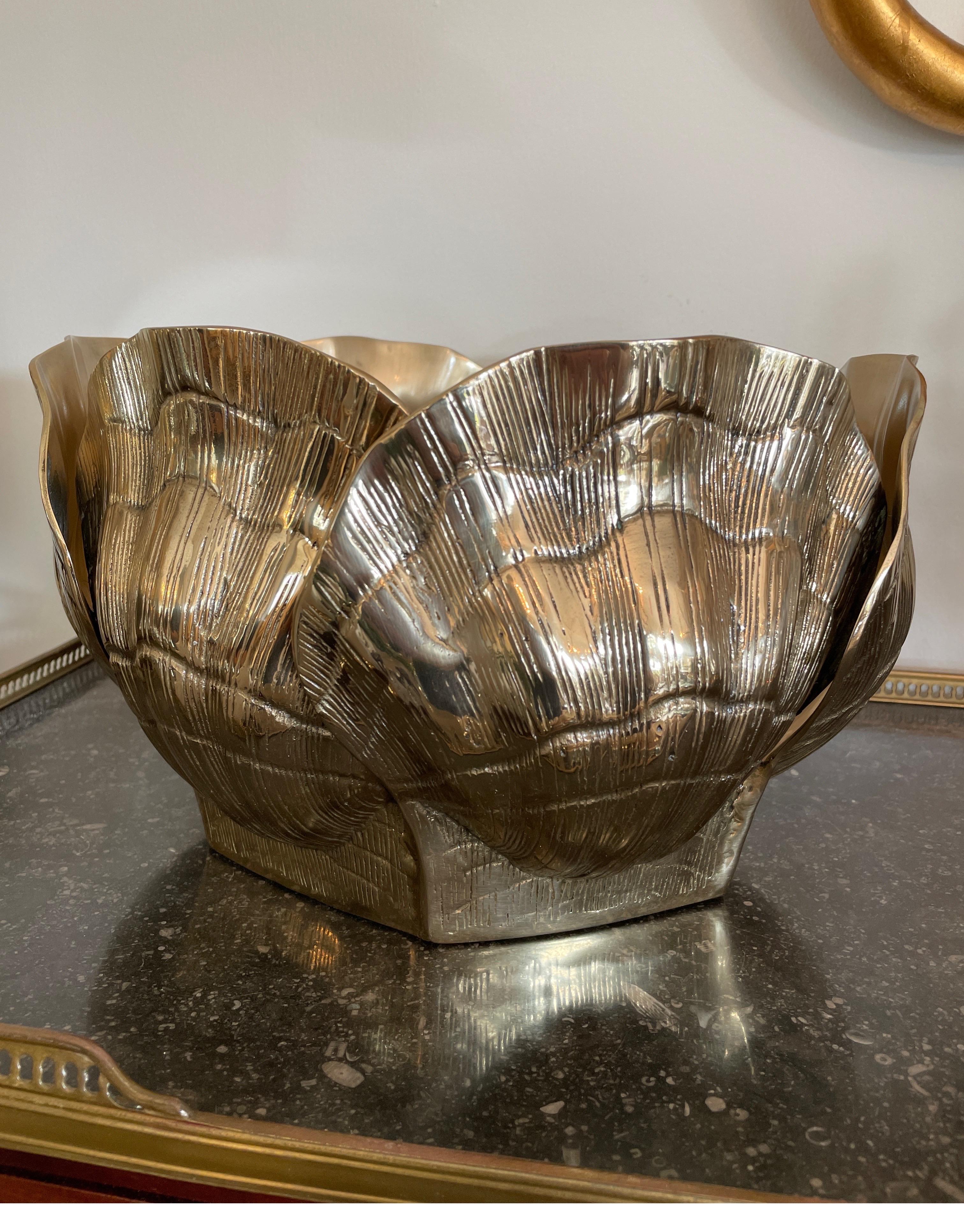 Large brass shell cache pot for your favorite arrangement or plant. Beautiful polished finish.