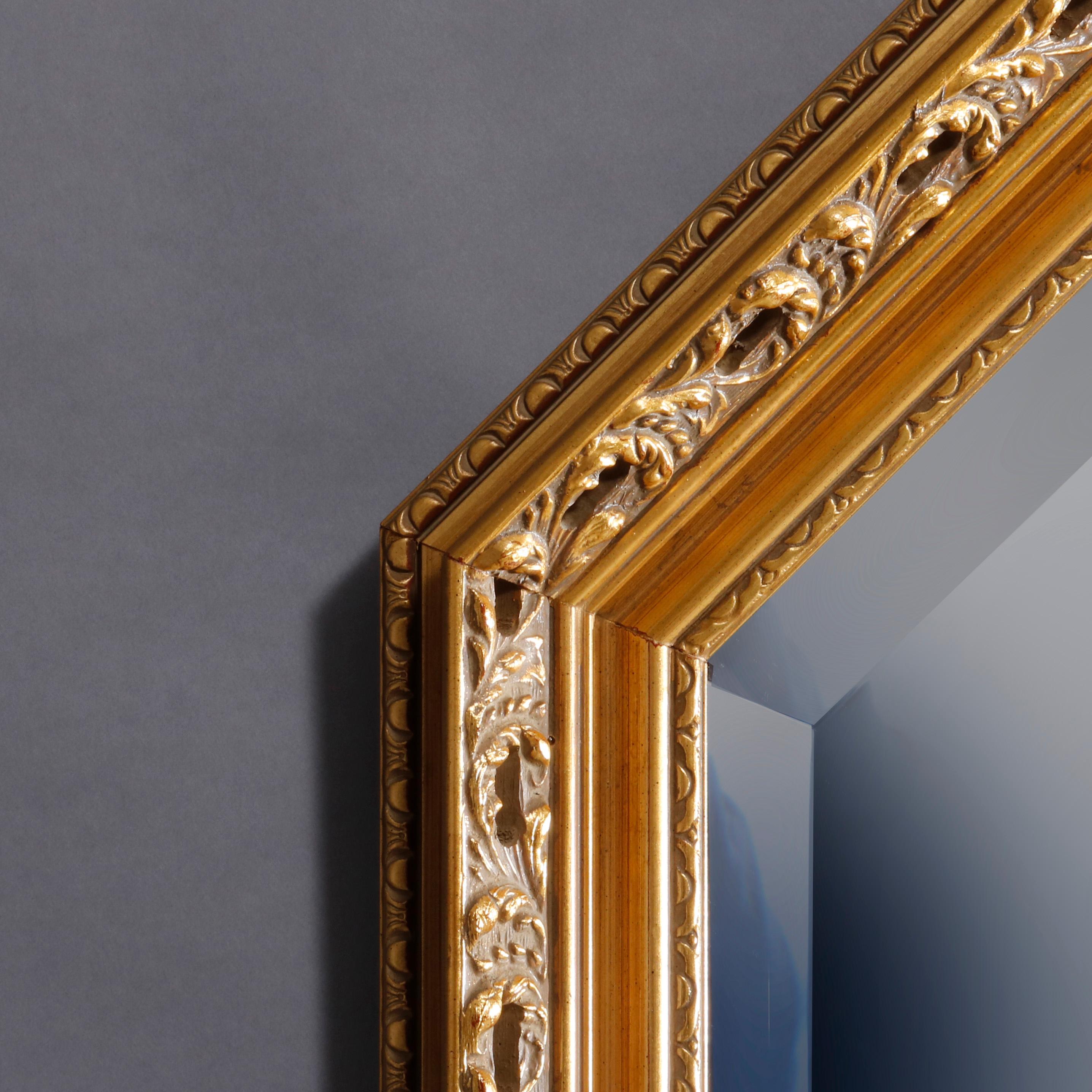 A vintage and large Continental style wall mirror offers giltwood foliate frame housing beveled mirror, 20th century

Measures: 41.75