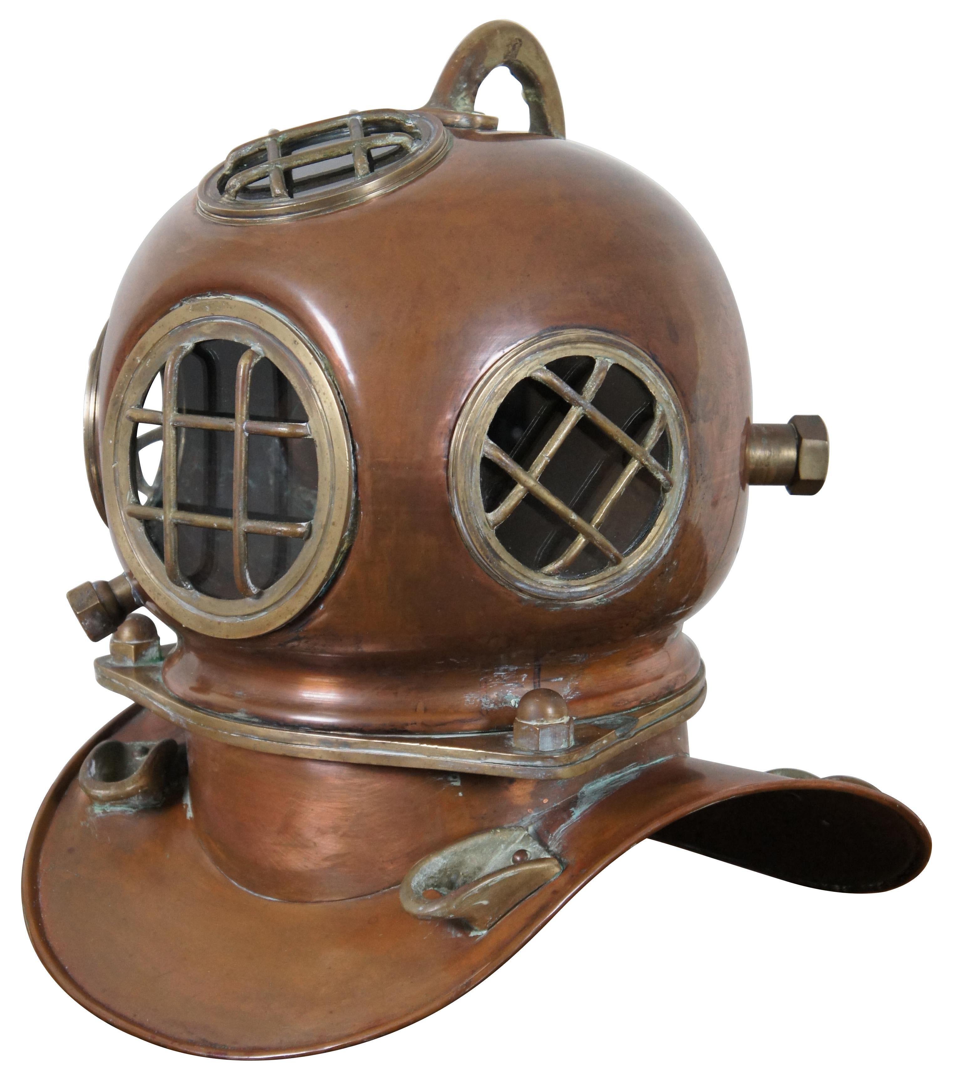 Vintage full size reproduction copper and brass deep sea diver’s helmet, converted to a night light or lamp. Measures: 18
