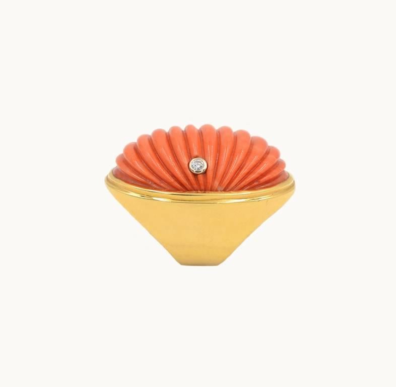 Vintage large scale coral ring 18 karat yellow gold from circa 1960.  The ring features a large ribbed carved coral section with a 0.15 carat round diamond bezel set on the side of the coral.  Unknown 