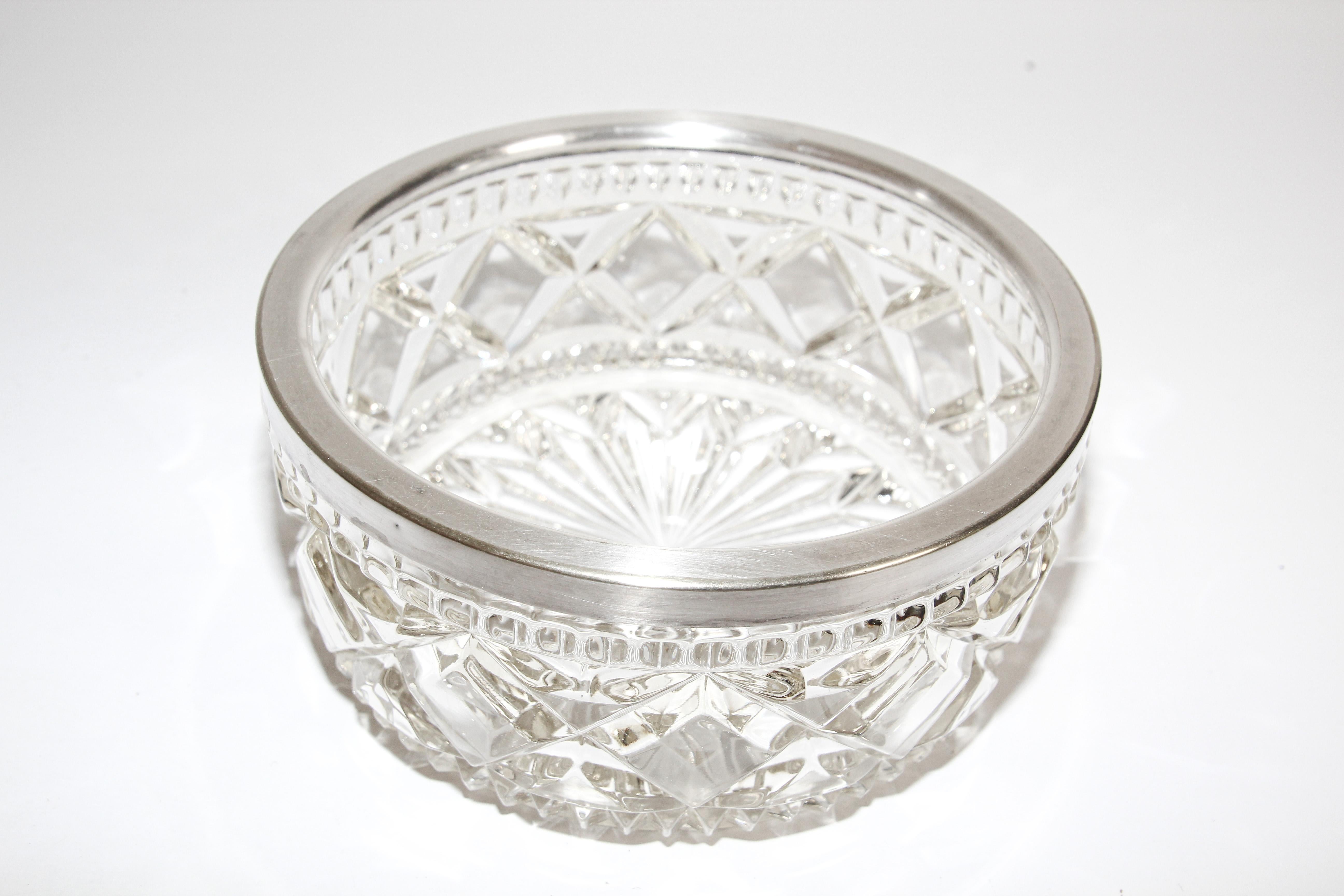 Vintage large heavy crystal bowl with silver plated rim produced by Raimond, England. 
Incised on the rim “Made in England” (see picture 4), the pattern features a beautiful cutout starburst pattern. The bottom of the bowl is gorgeous and offers