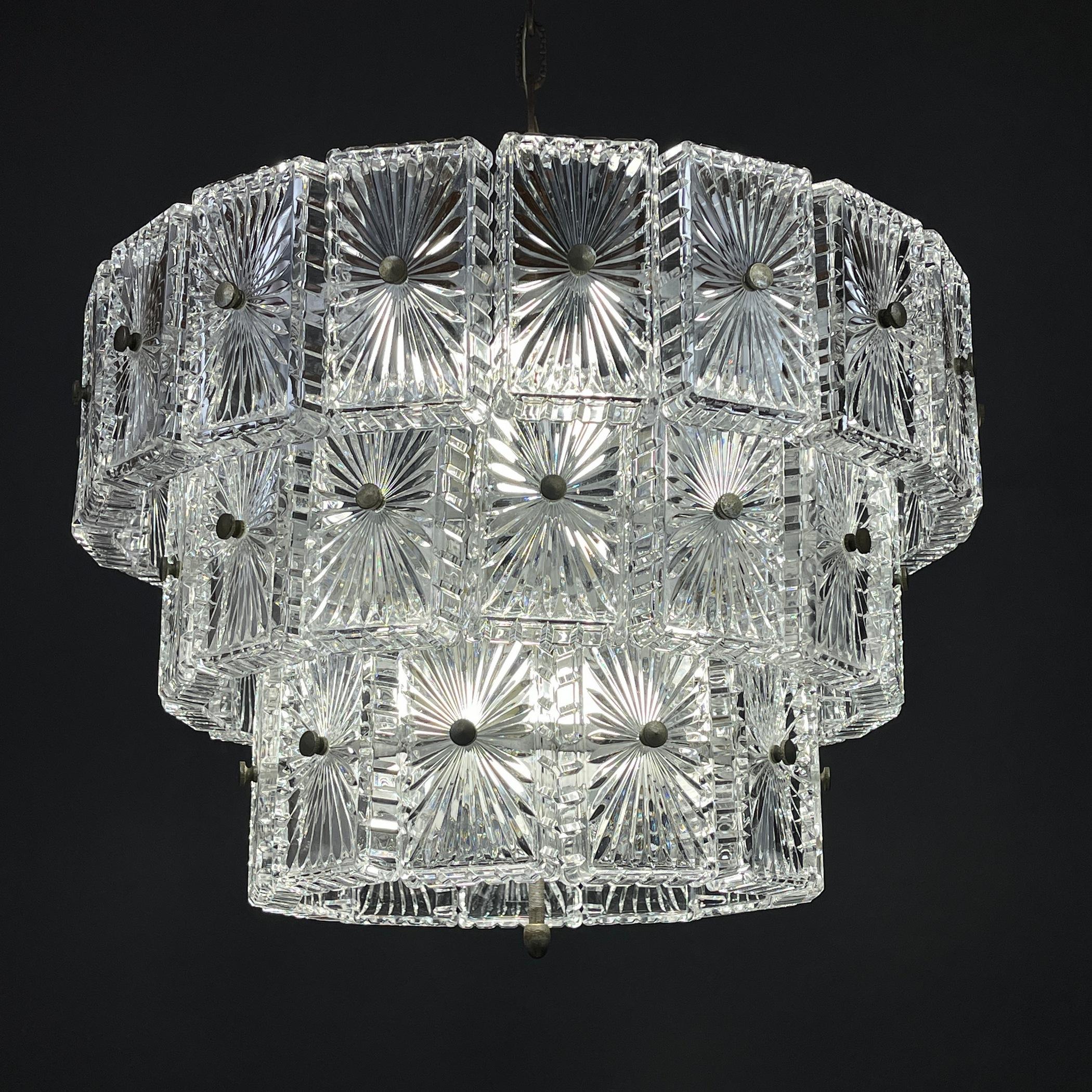 Unique vintage large crystal chandelier made in Italy in the 1960s. Three-tier metal base and 45 glass elements. The chandelier has a simple, clean design that makes it the perfect choice to decorate and illuminate any room of the house in a refined
