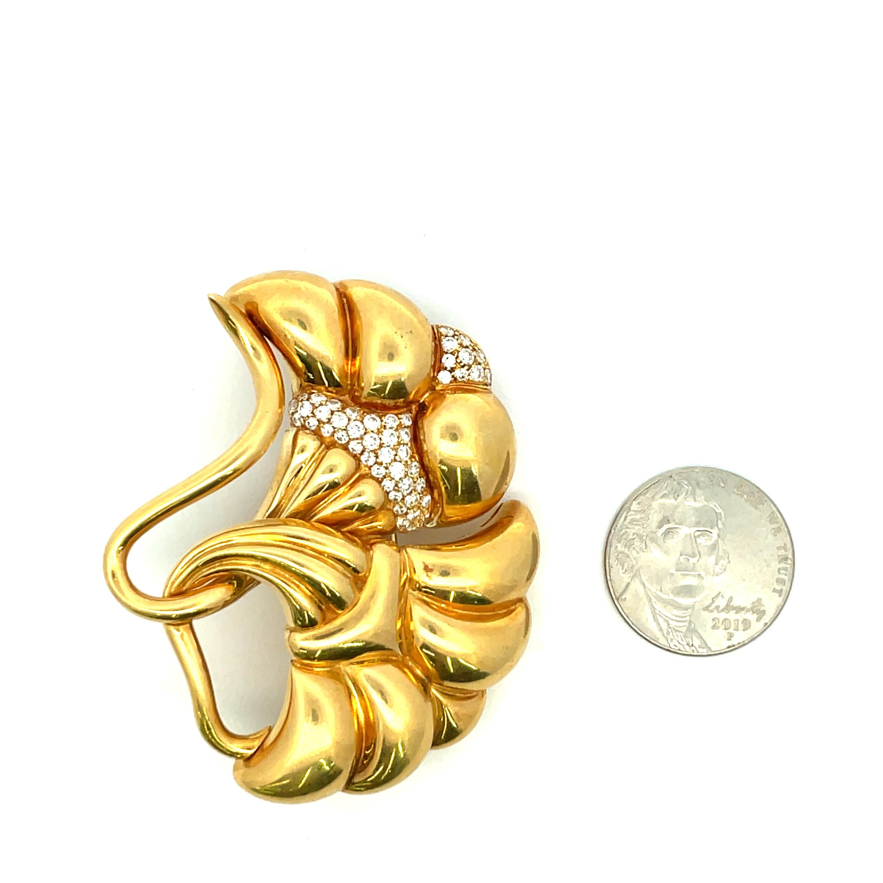 One large brooch featuring two florals with round brilliants weighing approximately 1.25 Carats in 18 Karat Yellow Gold, 46.7 grams. 