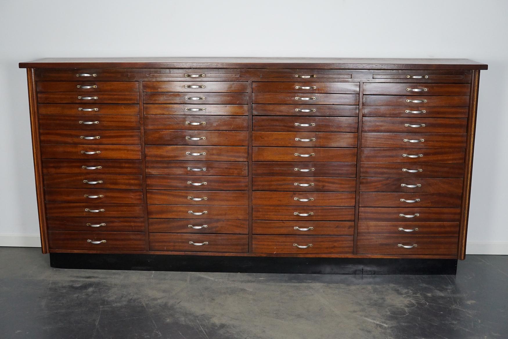 This jewelers / watchmakers cabinet was designed and made circa 1930 in the Netherlands. It features 48 mahogany fronted drawers in three different sizes: DWH 25 x 47 x 3.5 / 5.5 / 8 cm.