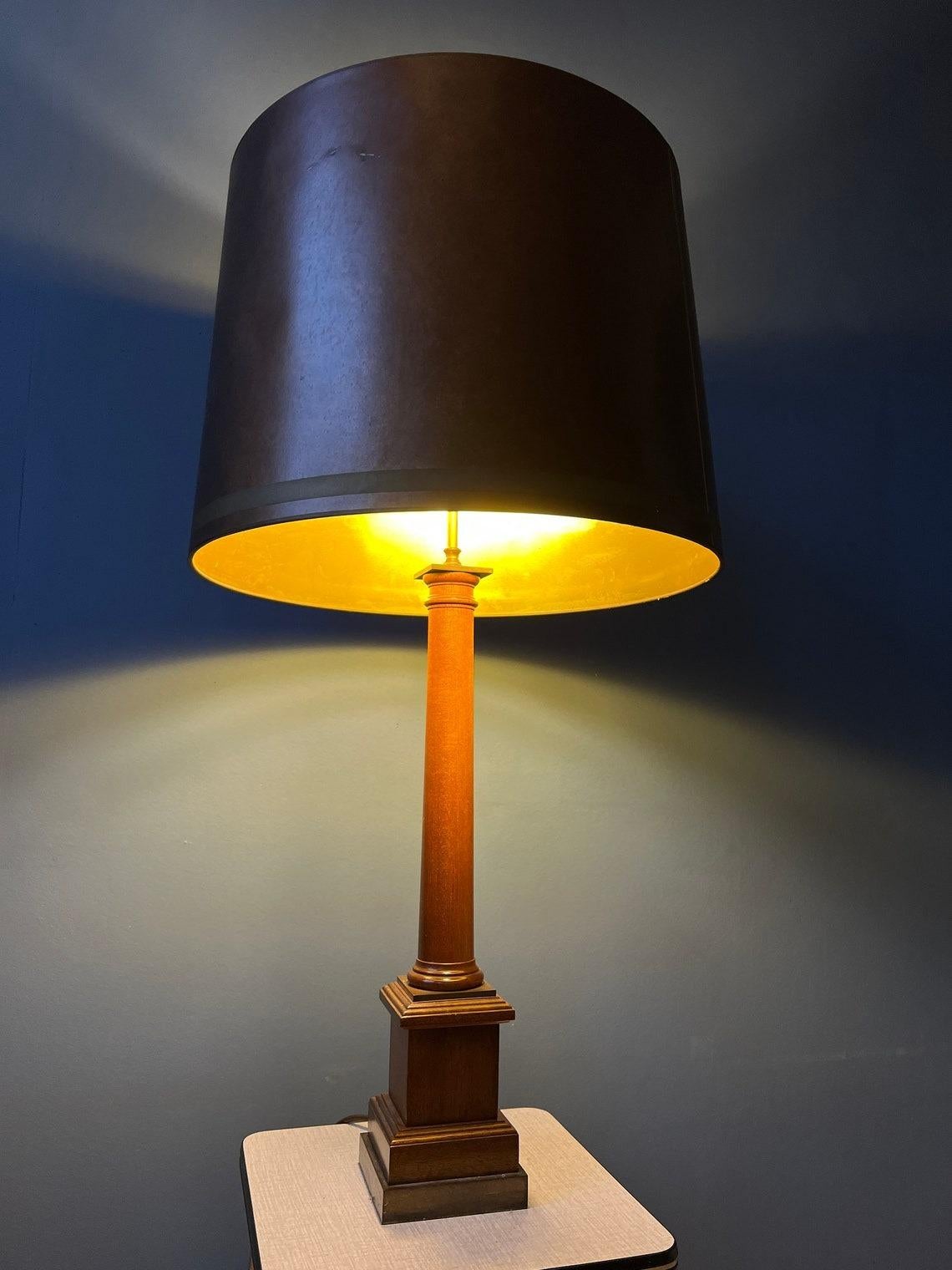 Big eclectic vintage table lamp wooden base and copper coloured shade. The lamp requires two E27/26 lightbulbs and currently has an EU-plug.

Additional information:
Materials: Fabric, wood
Period: 1970s
Dimensions: ø Shade: 38 cm
Height Shade: 66