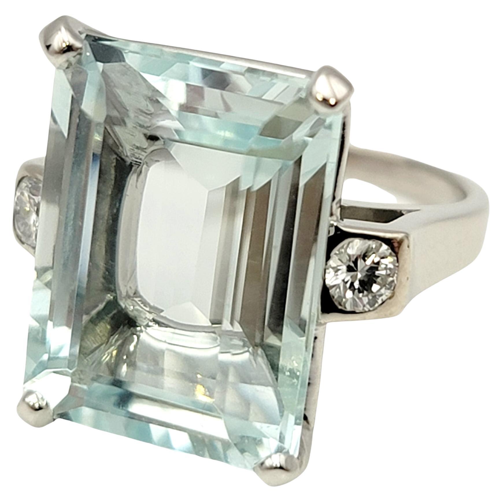 Ring size: 4.75

Stunningly beautiful aquamarine and diamond cocktail ring. This eye-catching piece makes a big statement with its impressive size and exquisite color. The incredible emerald cut aquamarine stone is 4 prong set in polished platinum