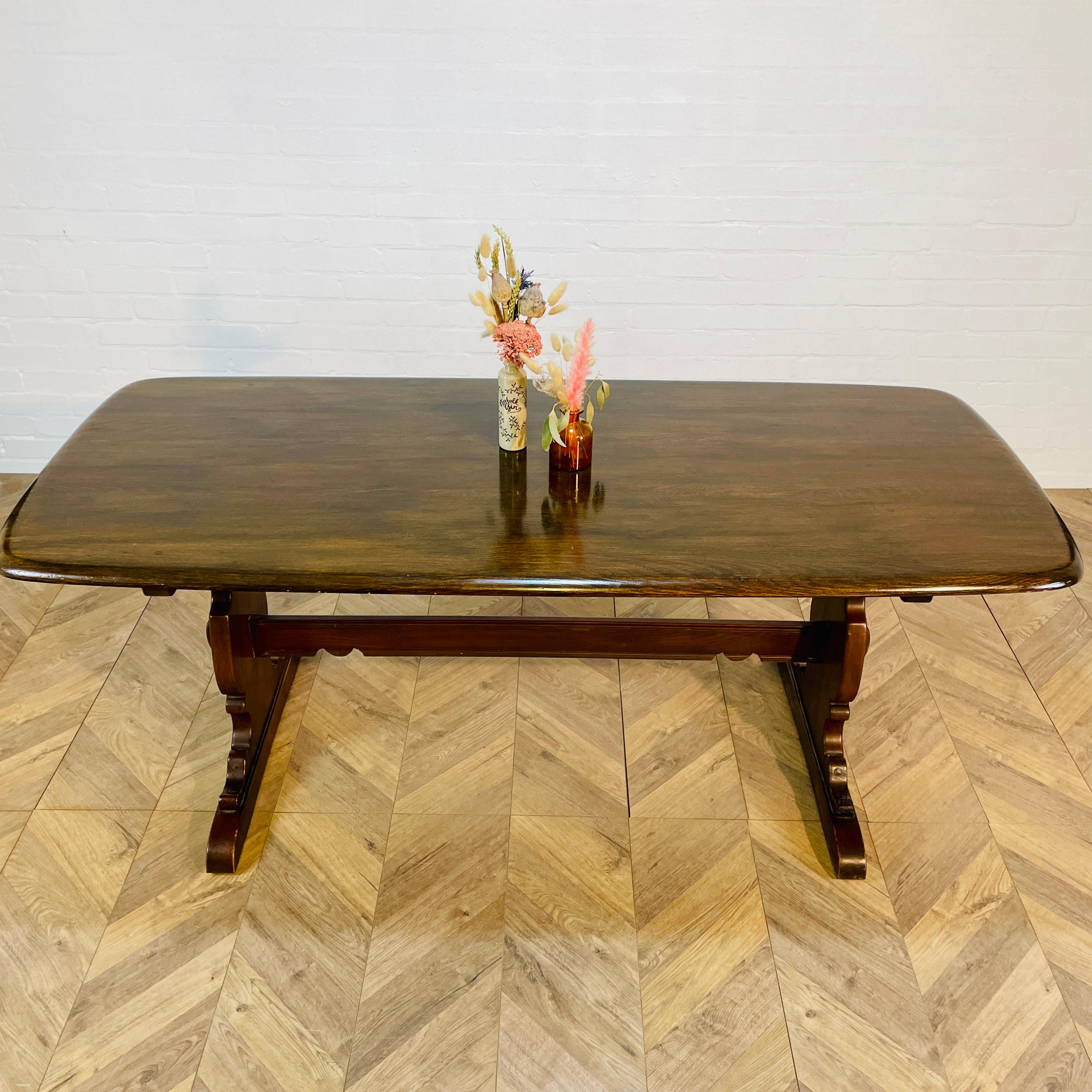 A Beautiful and Iconic, 1960s Ercol Refectory Table - Model Number 419

The table is from the company's popular Old Colonial range. Designed to sit up to six people, this is a classic piece from Ercol history.

The top is made from elm.

The table