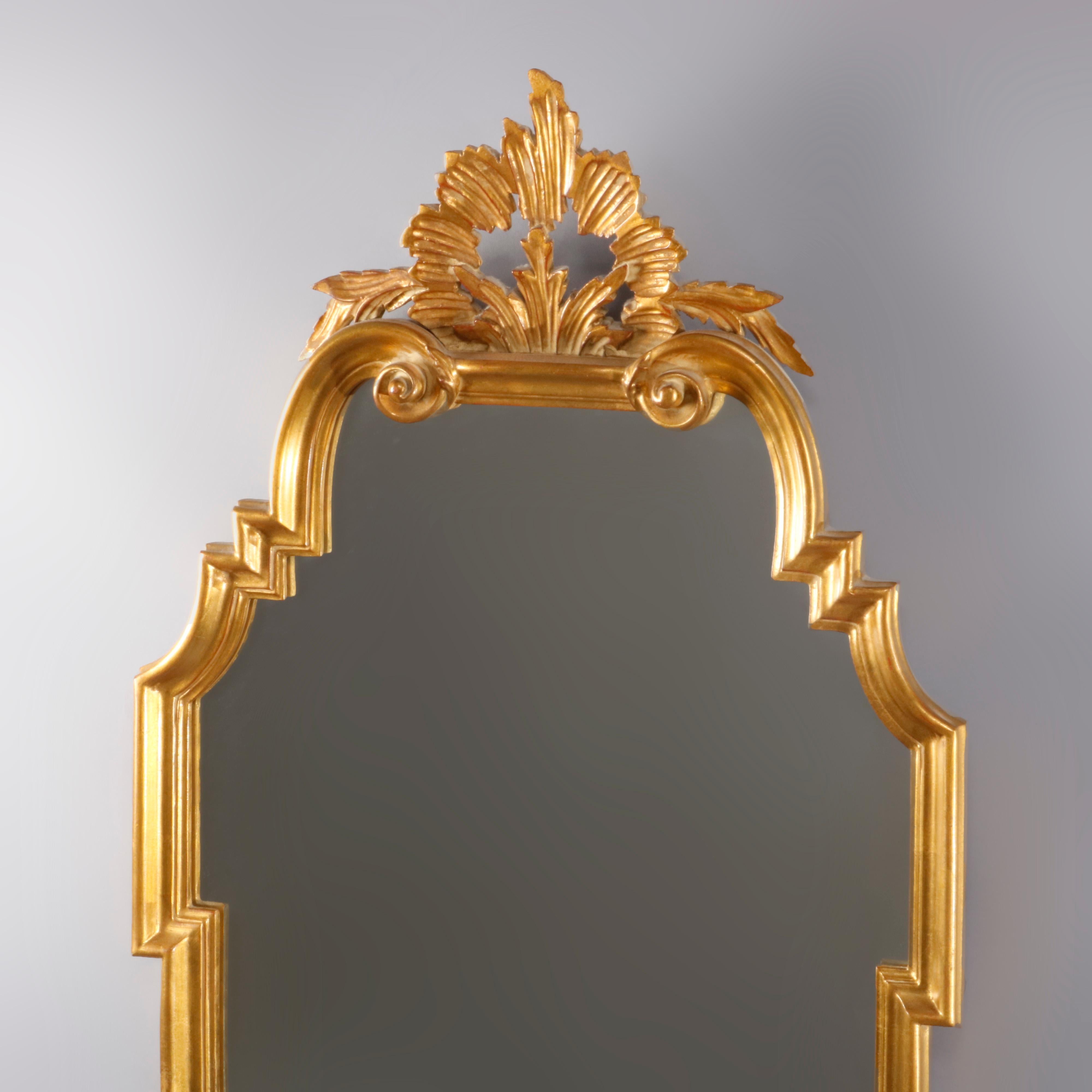 A vintage and large French Louis XVI style wall mirror by Carvers' Guild offers handcrafted giltwood frame with pierced foliate crest surmounting scrolled arch form mirror, 20th century

Measures: 47.5