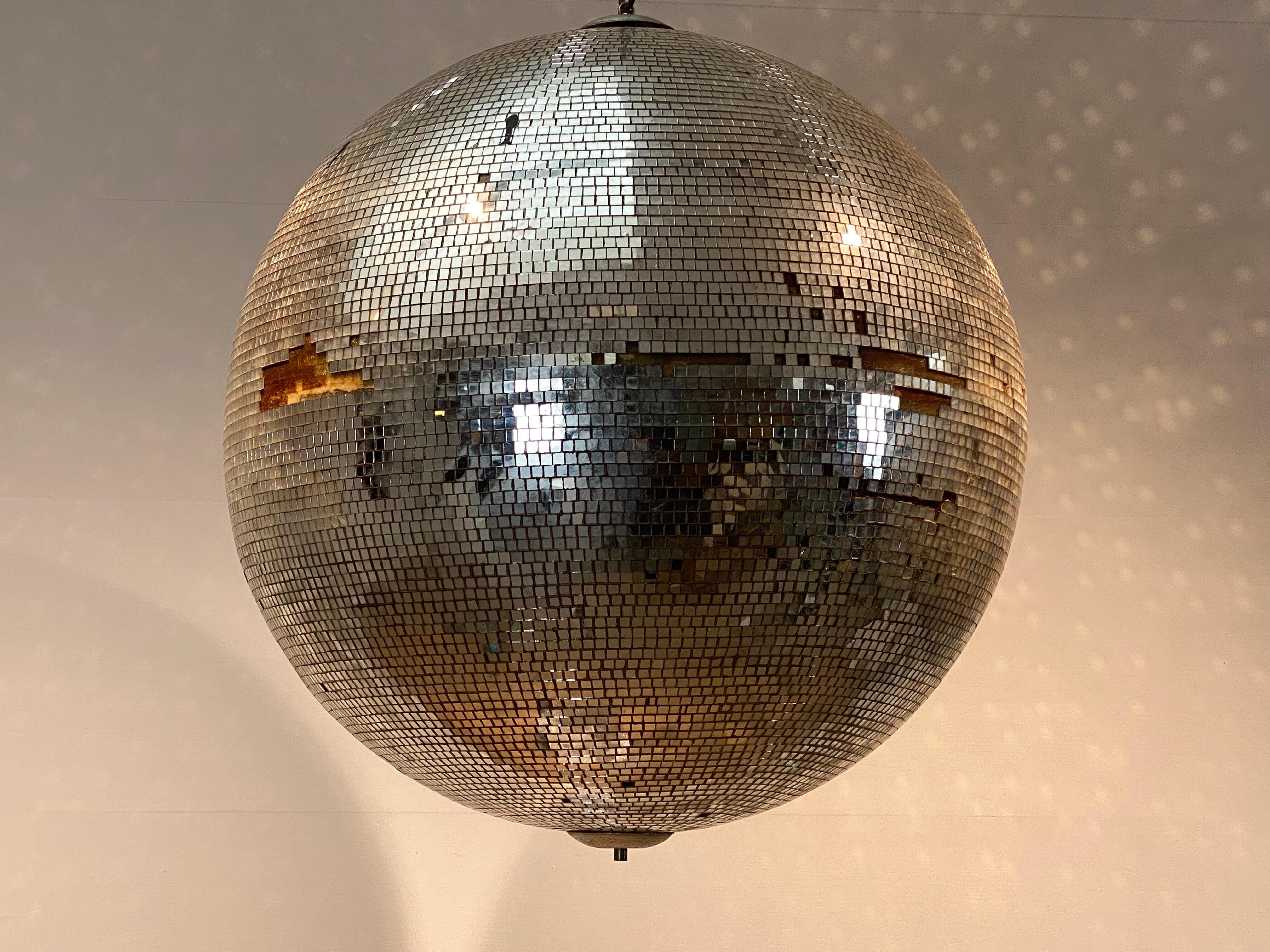 Exceptional and large Vintage disco Ball from an ancient cinema 
Rialto from the city Ostend,
made out of individually cut square pieces of glass,
illuminates beautifully, the ball has also its original rotating system,
different parts of glass are
